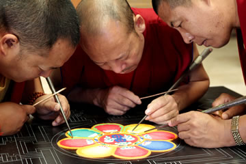 Monks working on a sand mandala