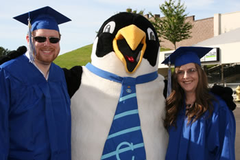 Mascot Oswald congratulates two members of the Clark College class of 2008