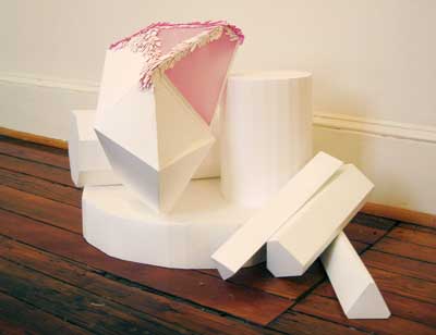 arrangement of paper sculptural pieces in geometric shapes