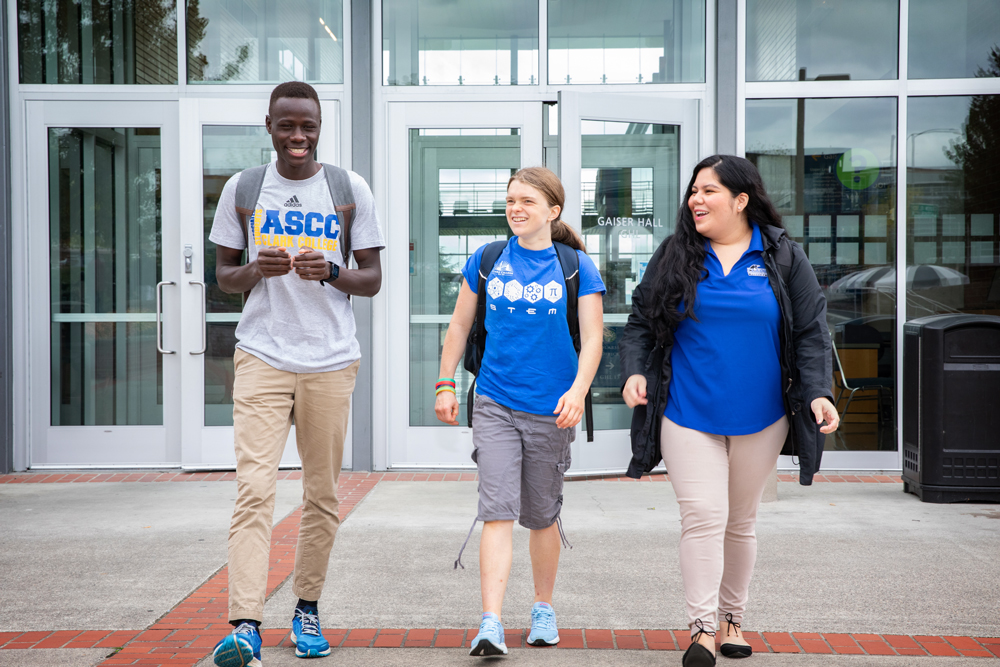 Three students walking out of Gaiser Hall 