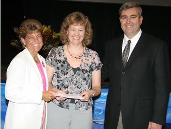 Clark College Foundation President Lisa Gibert and Clark College President Bob Knight congratulate Lynn Schinzing
