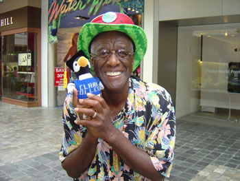Wally Amos holds a stuffed penguin