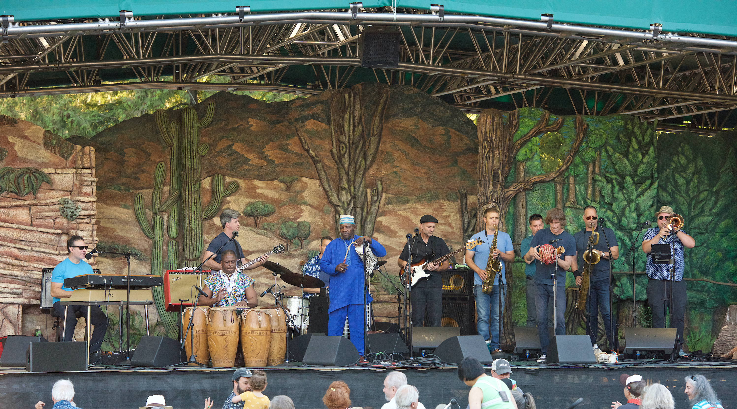 Jujuba band members playing their music instruments on a stage.
