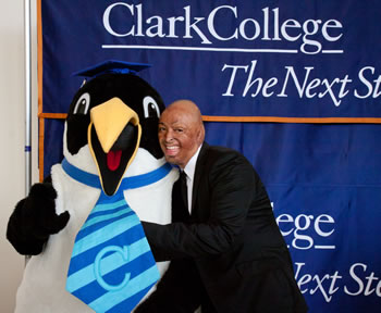 Commencement speaker J.R. Martinez with Clark's penguin mascot Oswald