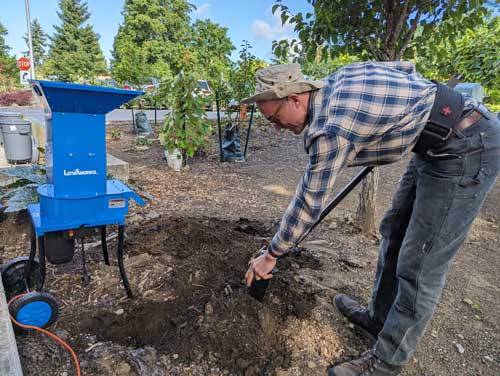 Chef Sonny adds nutrient-rich compost into the garden soil