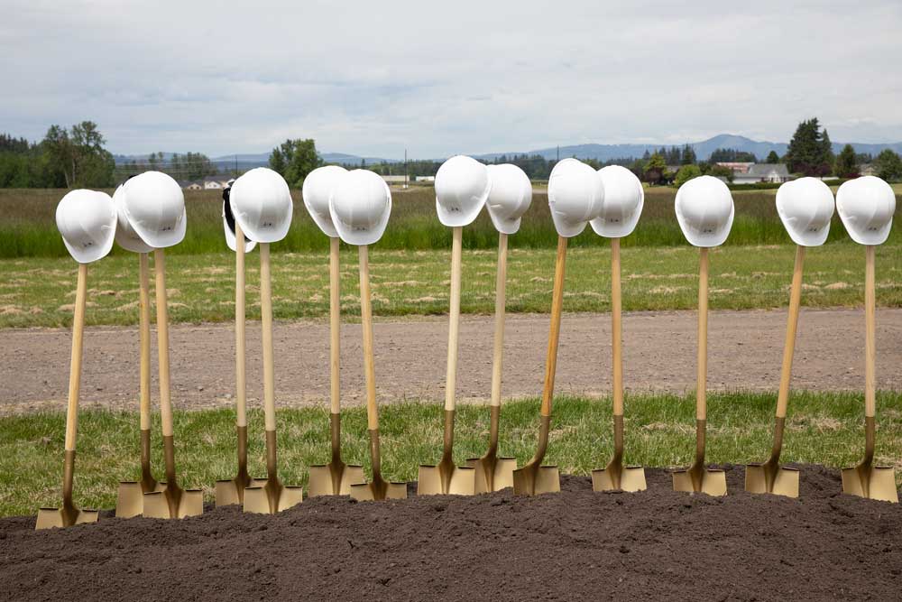 A line of hardhats on shovels