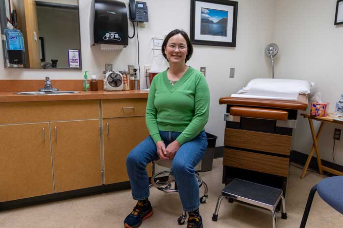 A person sitting on a swivel chair.