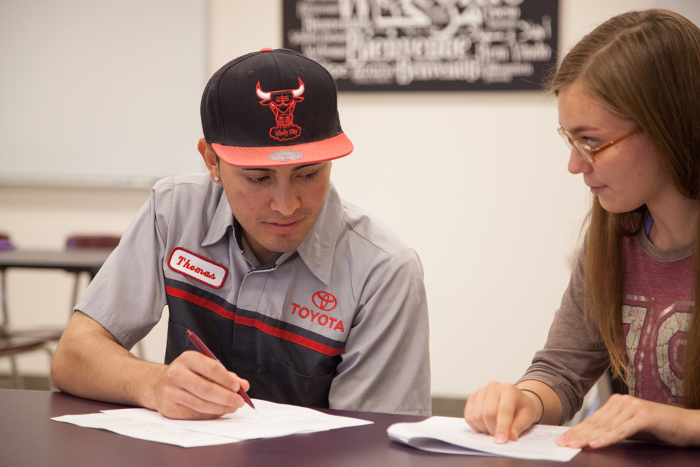 Student working with a writing tutor