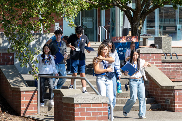 Students walking down a set of stairs on a college campus.