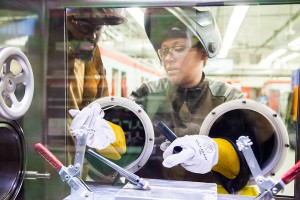 Damond Batties looks on while Nicole Doyle shows him the Argon Purge Chamber.