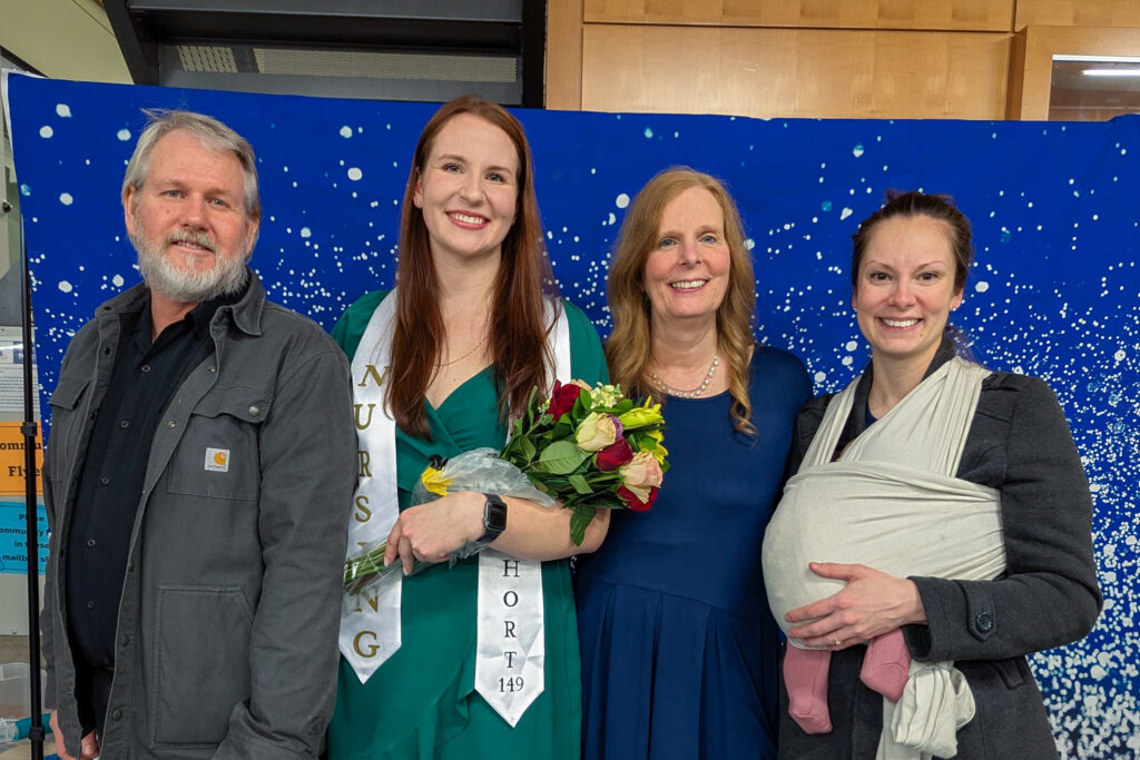 Four people, one holds baby