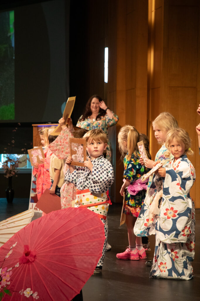 children hold artworks