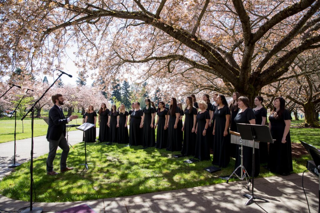 choir sings under trees