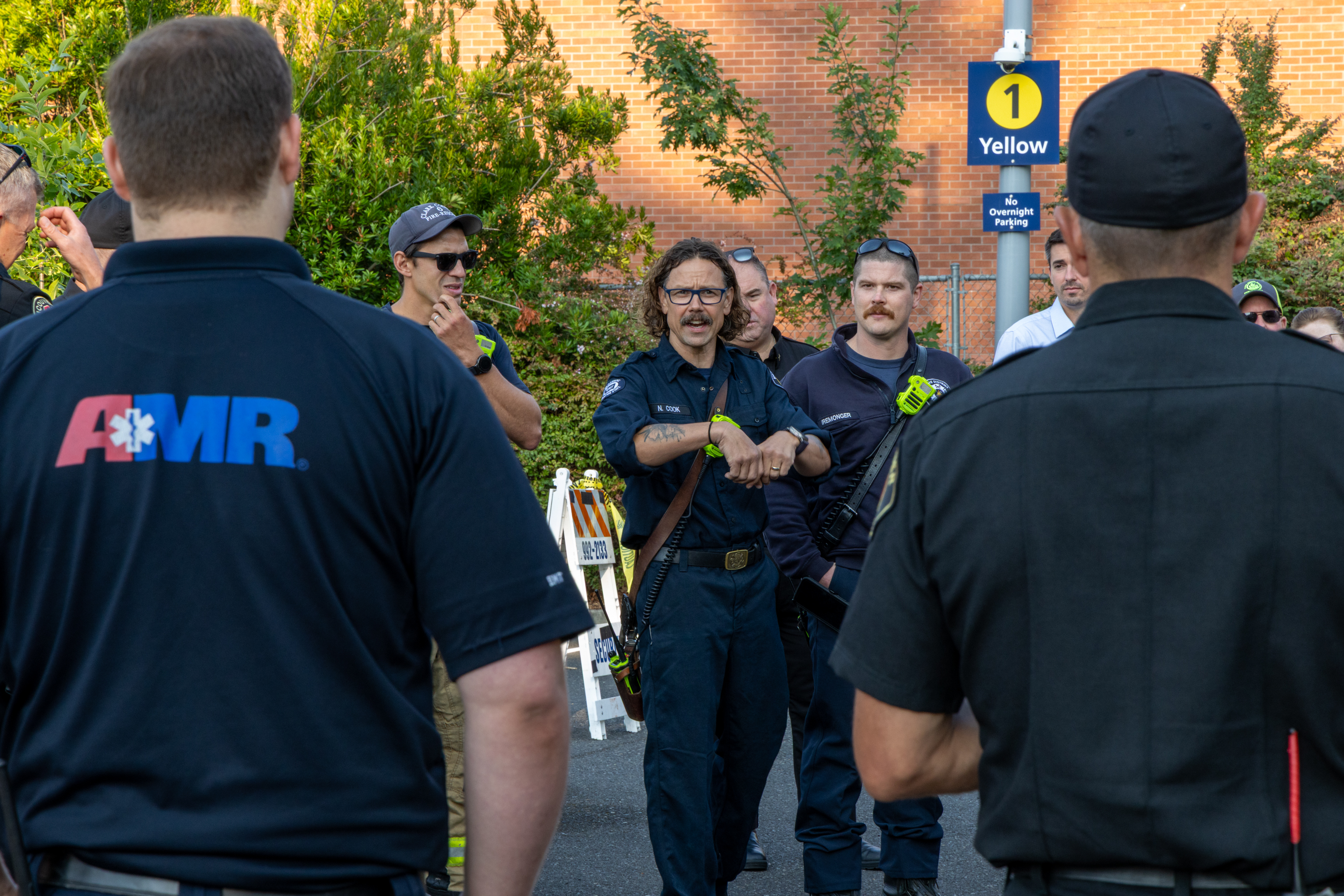 Group of police officers as one gives directions for a drill outside of Clark's STEM Building