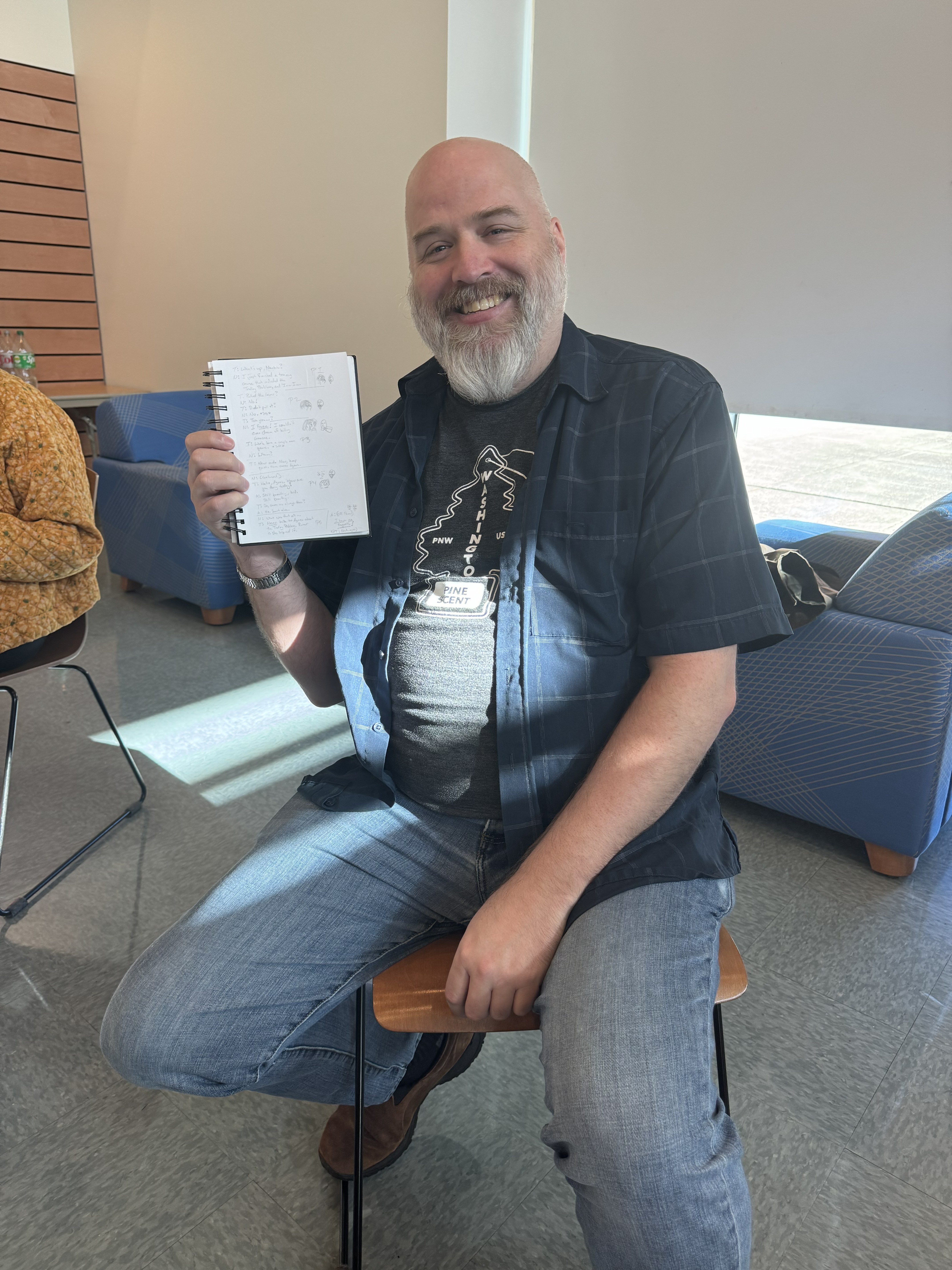 Sean Gentry holding up his notebook