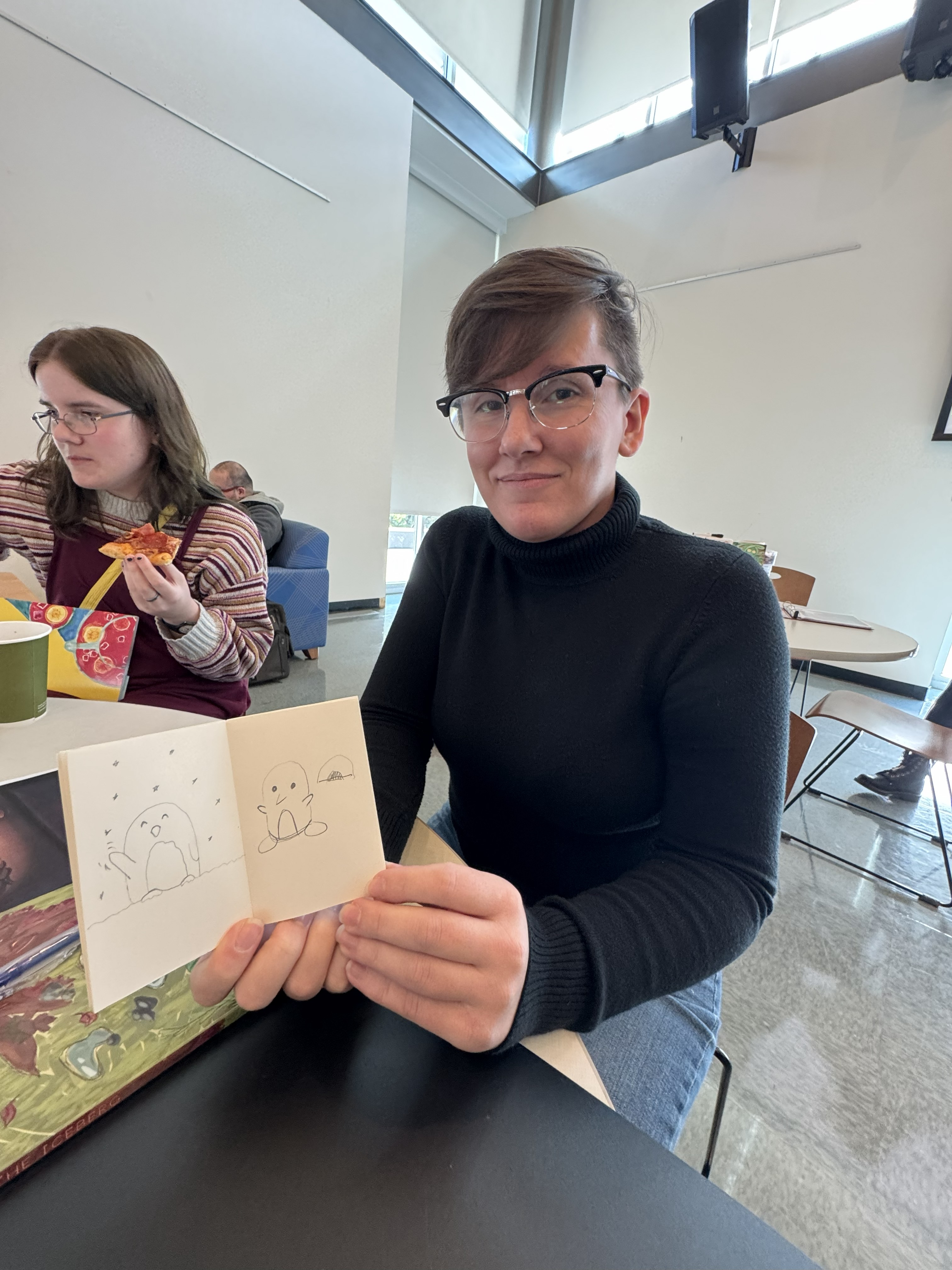Lindsey Bross holding a zine