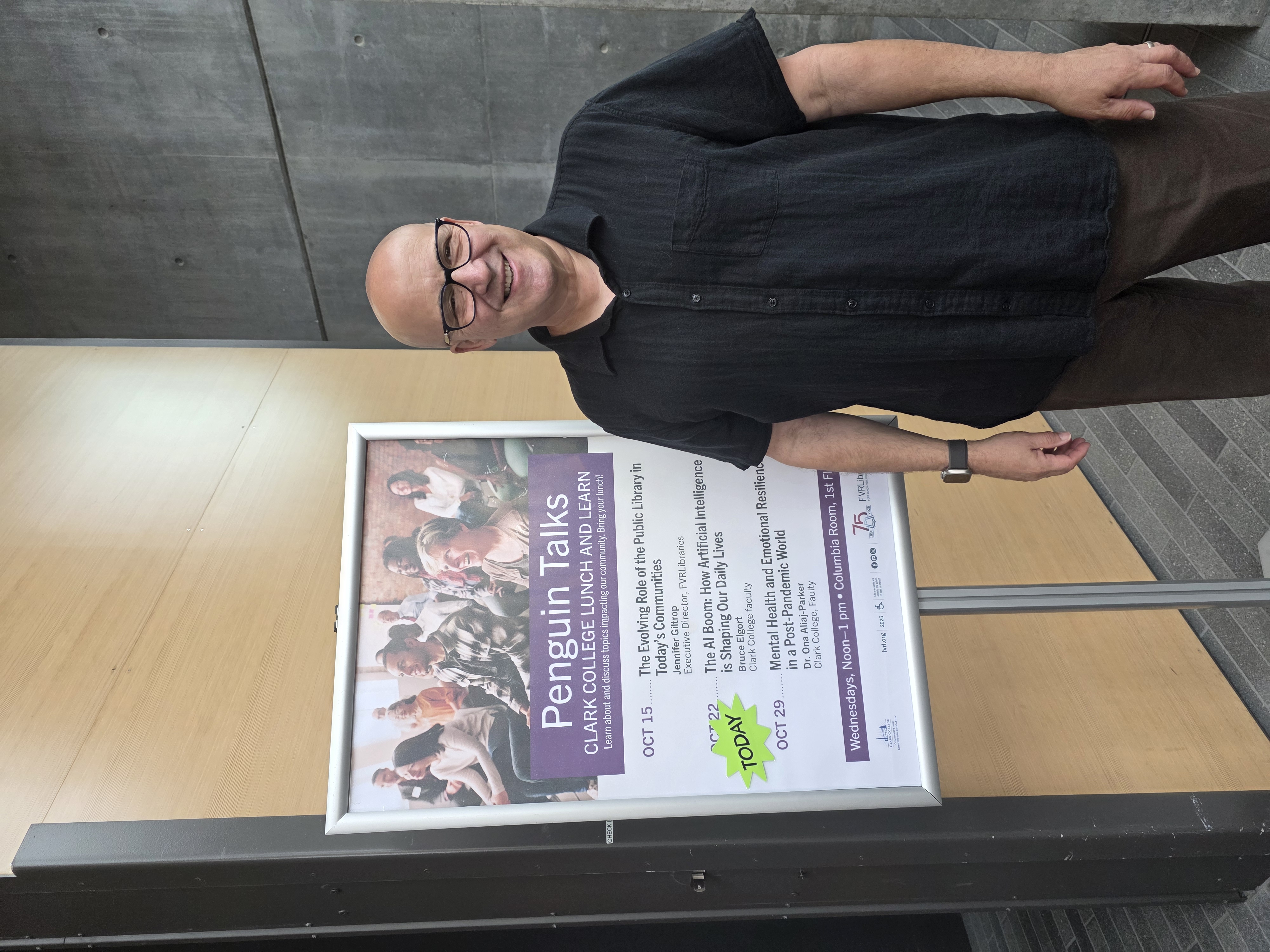 Bruce Elgort standing in front of sign listing Penguin Talks
