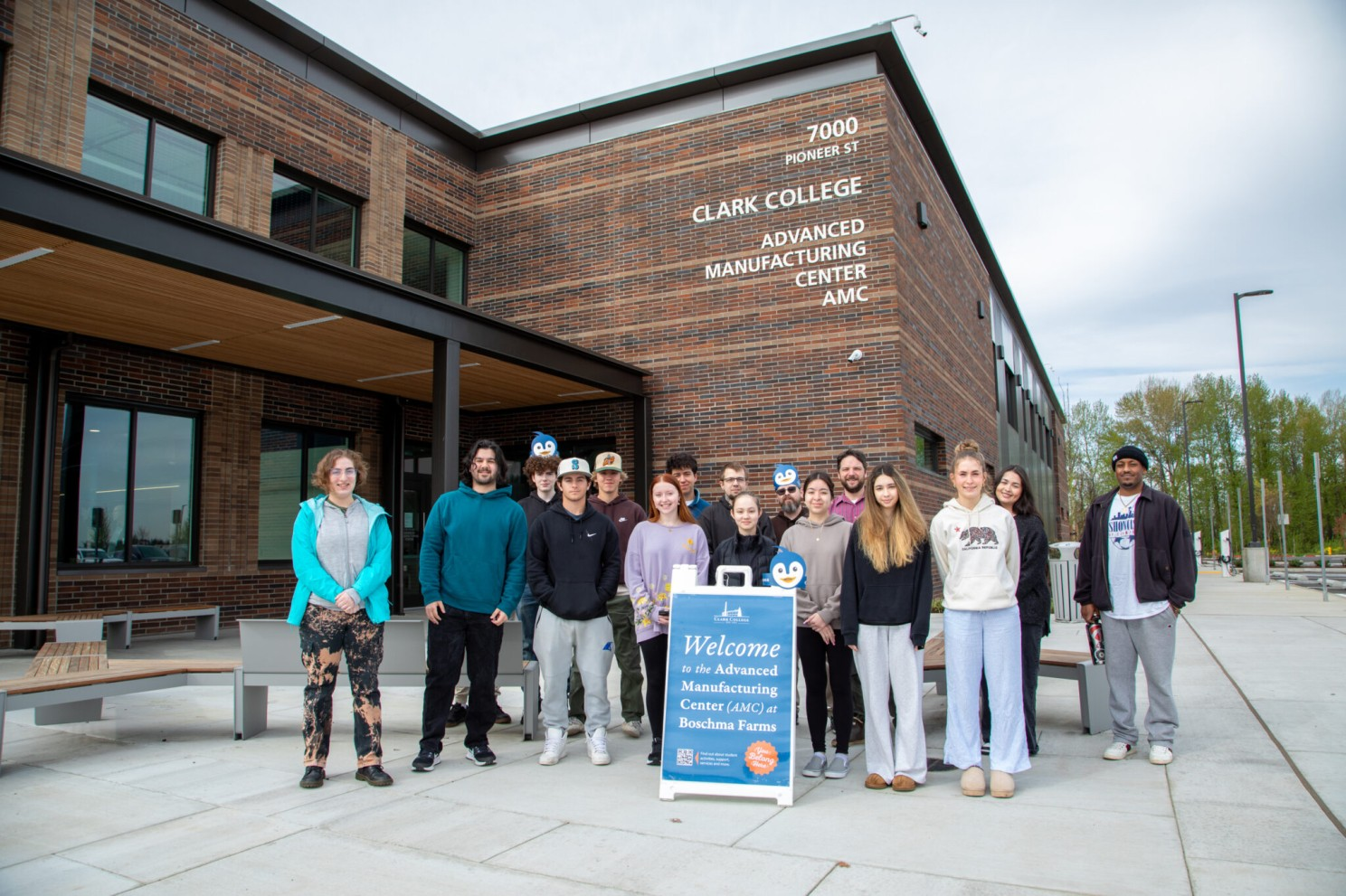 Group of students posing in front of new Advanced Manufacturing building
