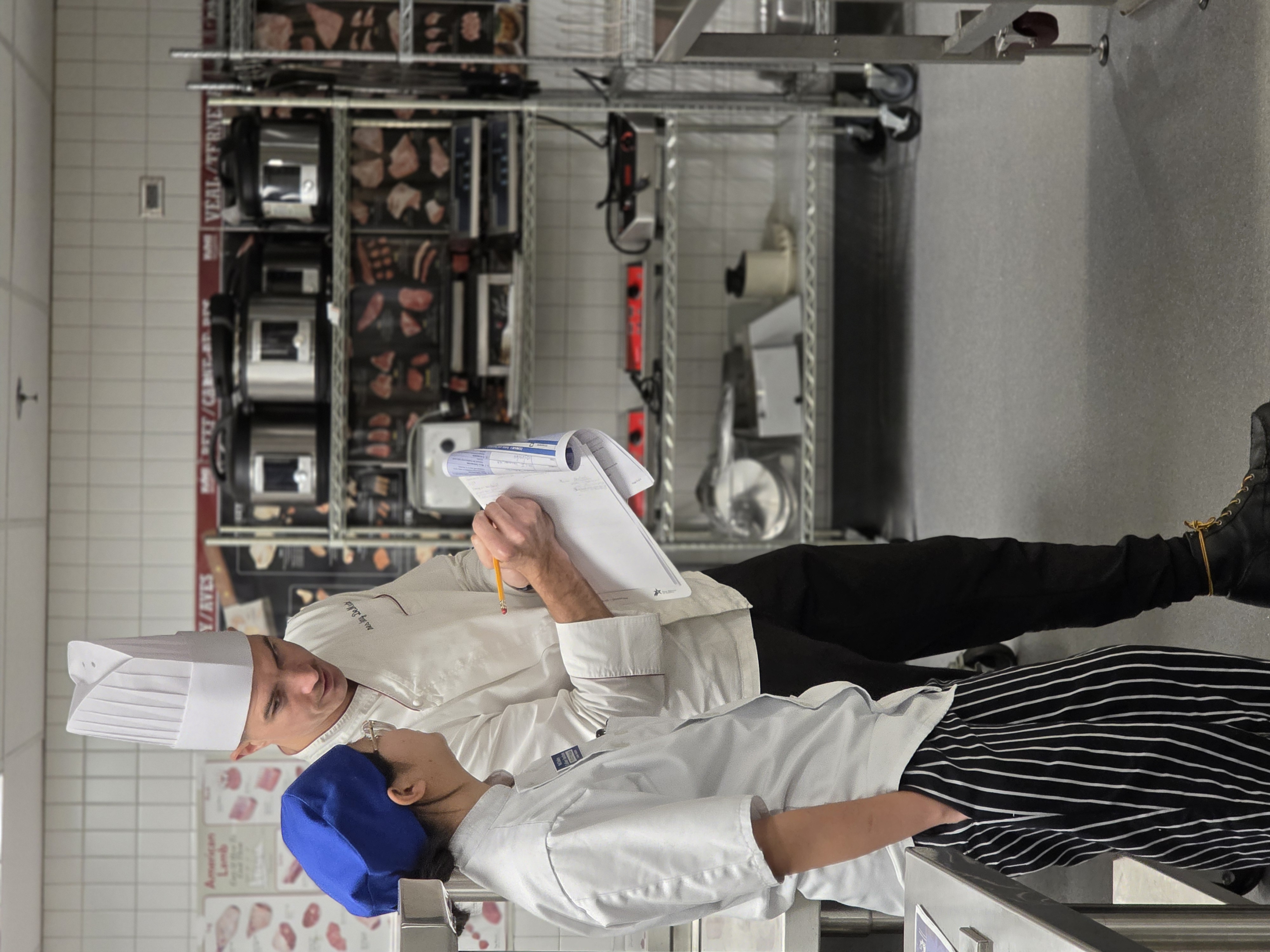 Chef Sonny showing a student certification requirements