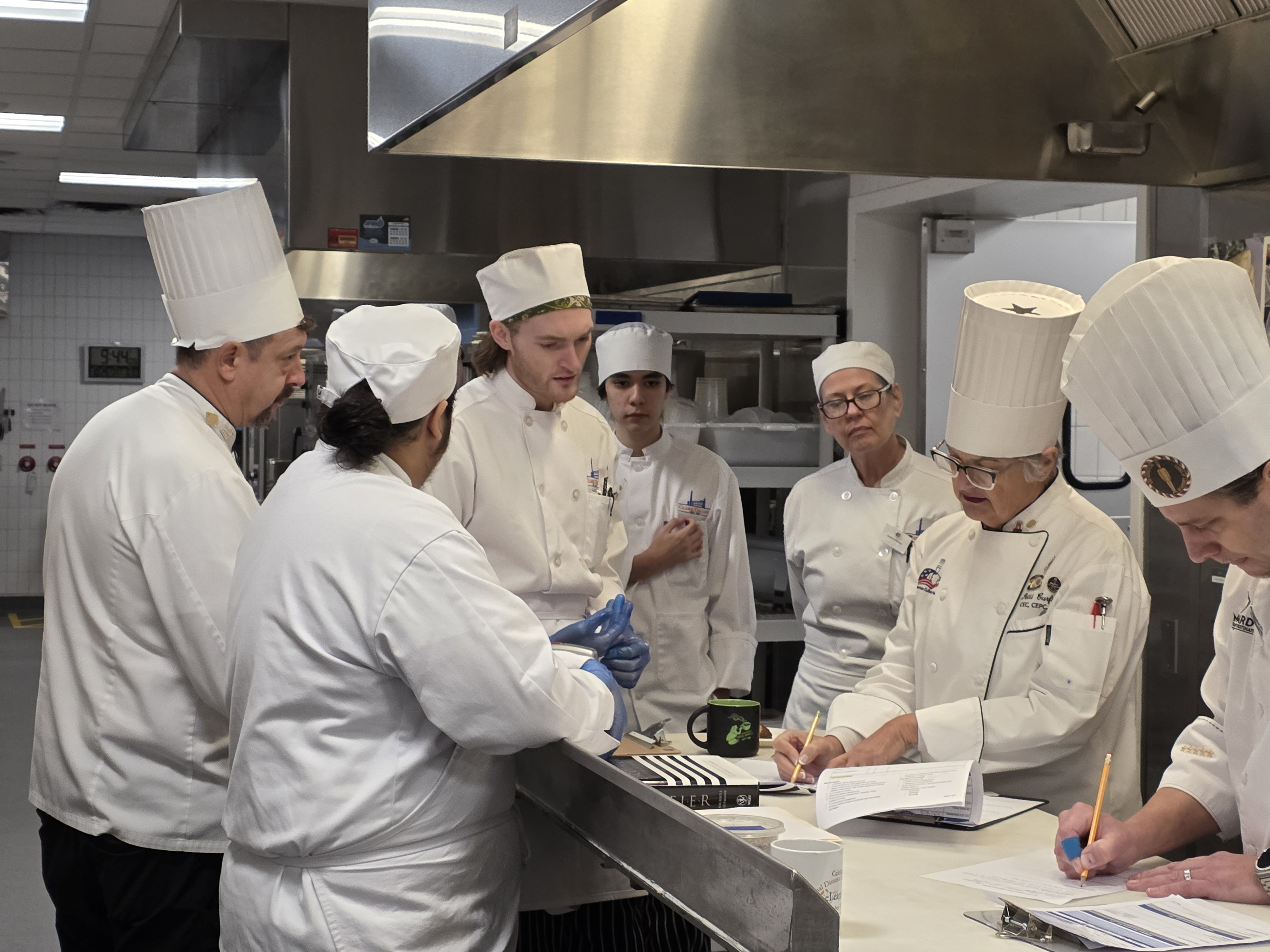 Group of students gathered around guest evaluator