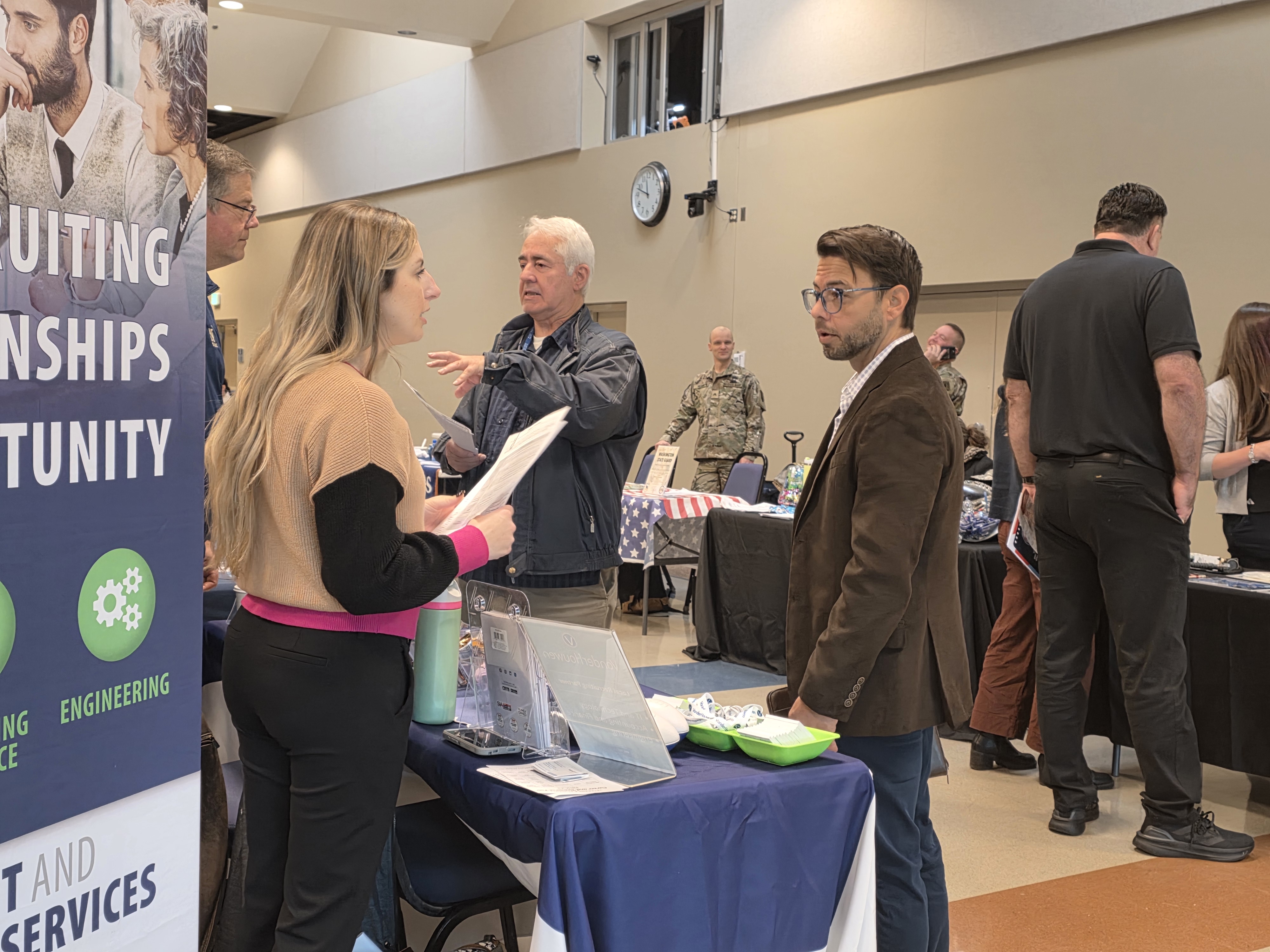 Veteran John speaking with a vendor at the VCOE Career Fair
