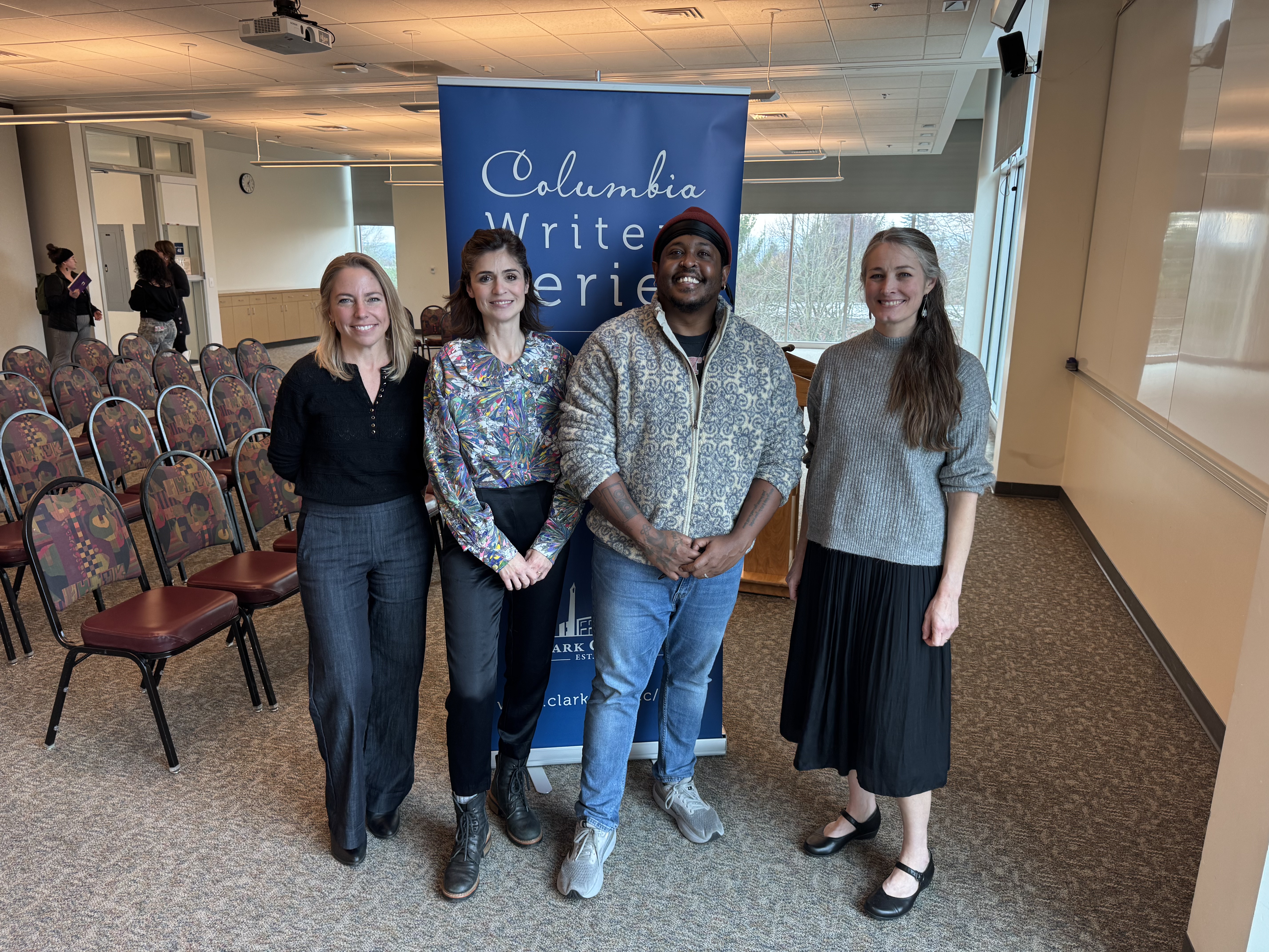 Professor Alexis Nelson, student Paula Blower, guest speaker Danez Smith, and Professor Dawn Knopf standing in front of the Columbia Writers Series banner