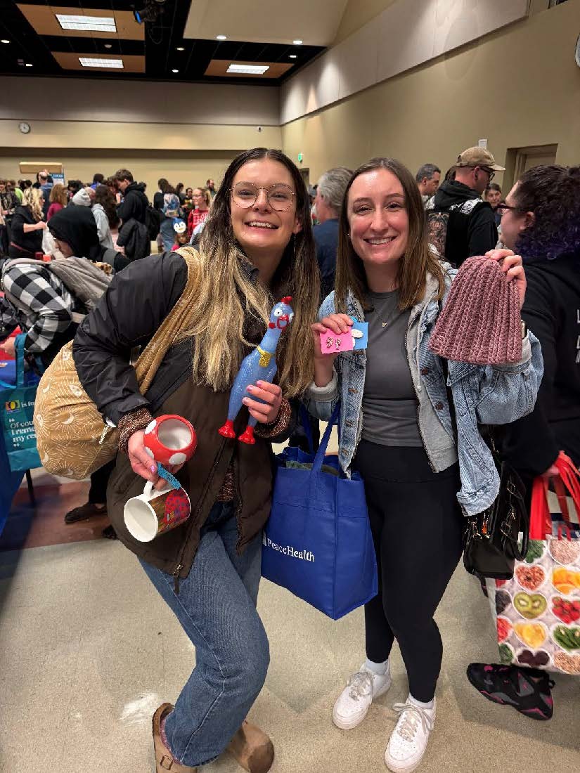 Students hold up their findings from the market