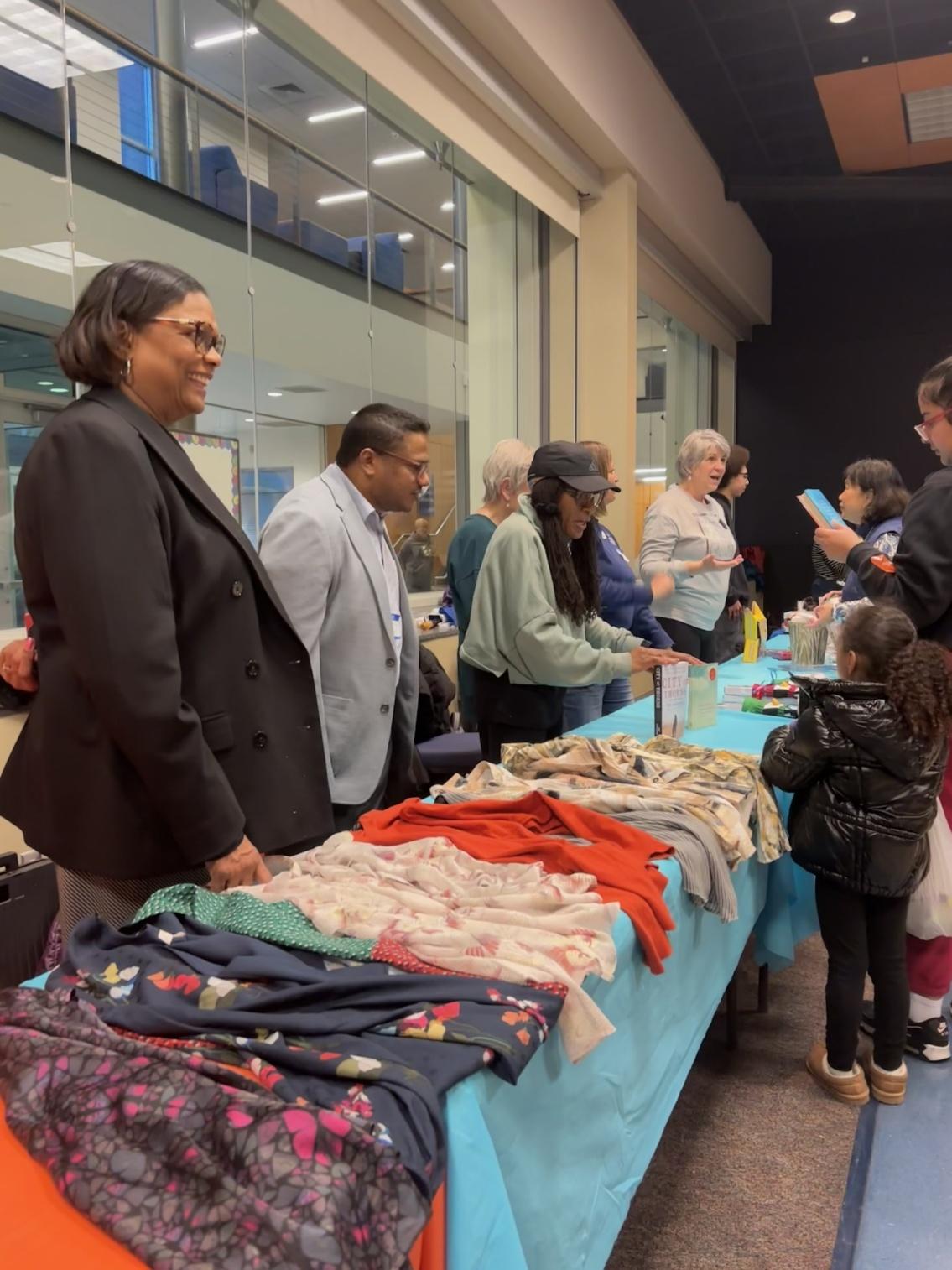 Dr. Edwards and Trustee members engage with students at their market table