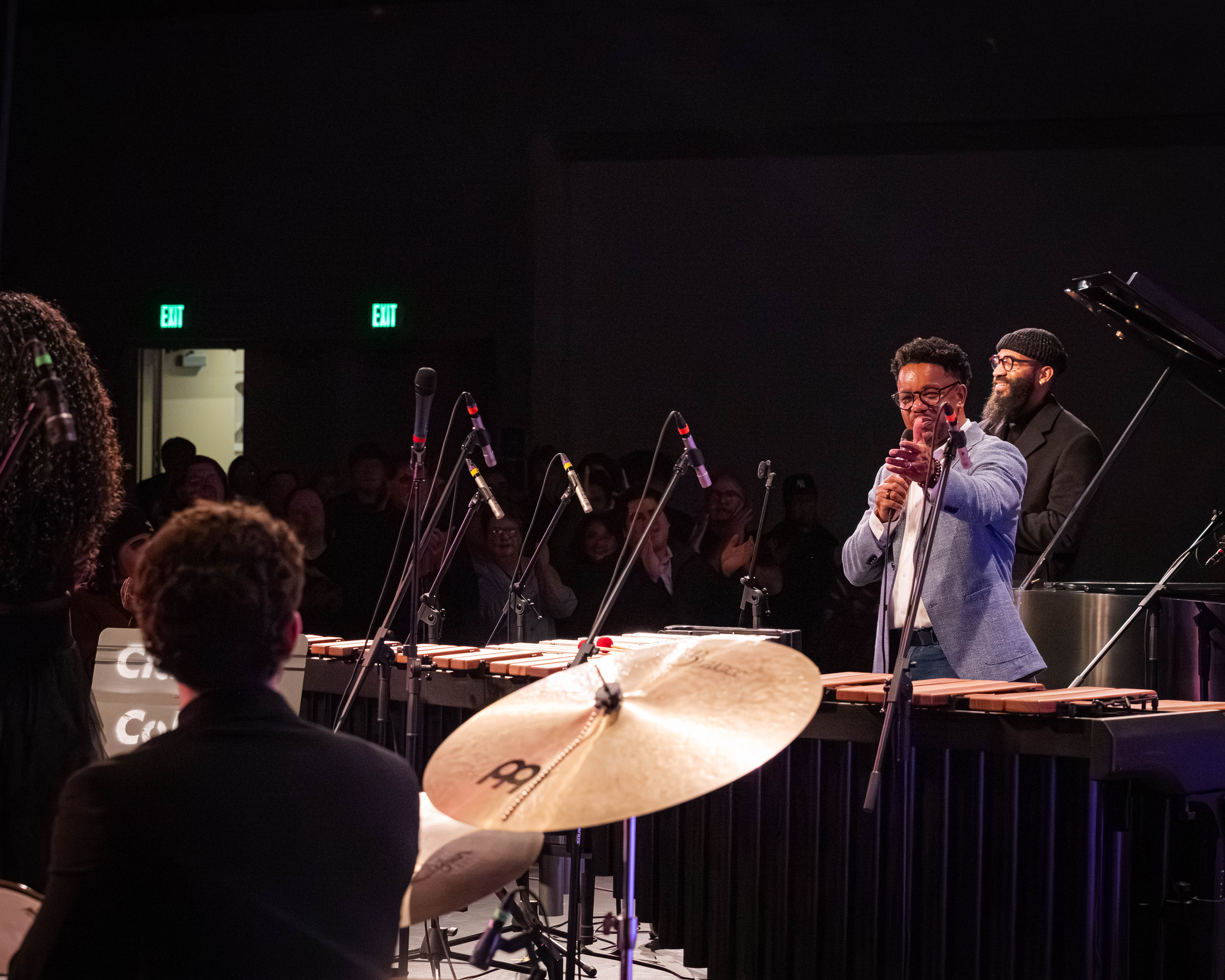 Stefon Harris smiling and gesturing toward student Blake Bruning