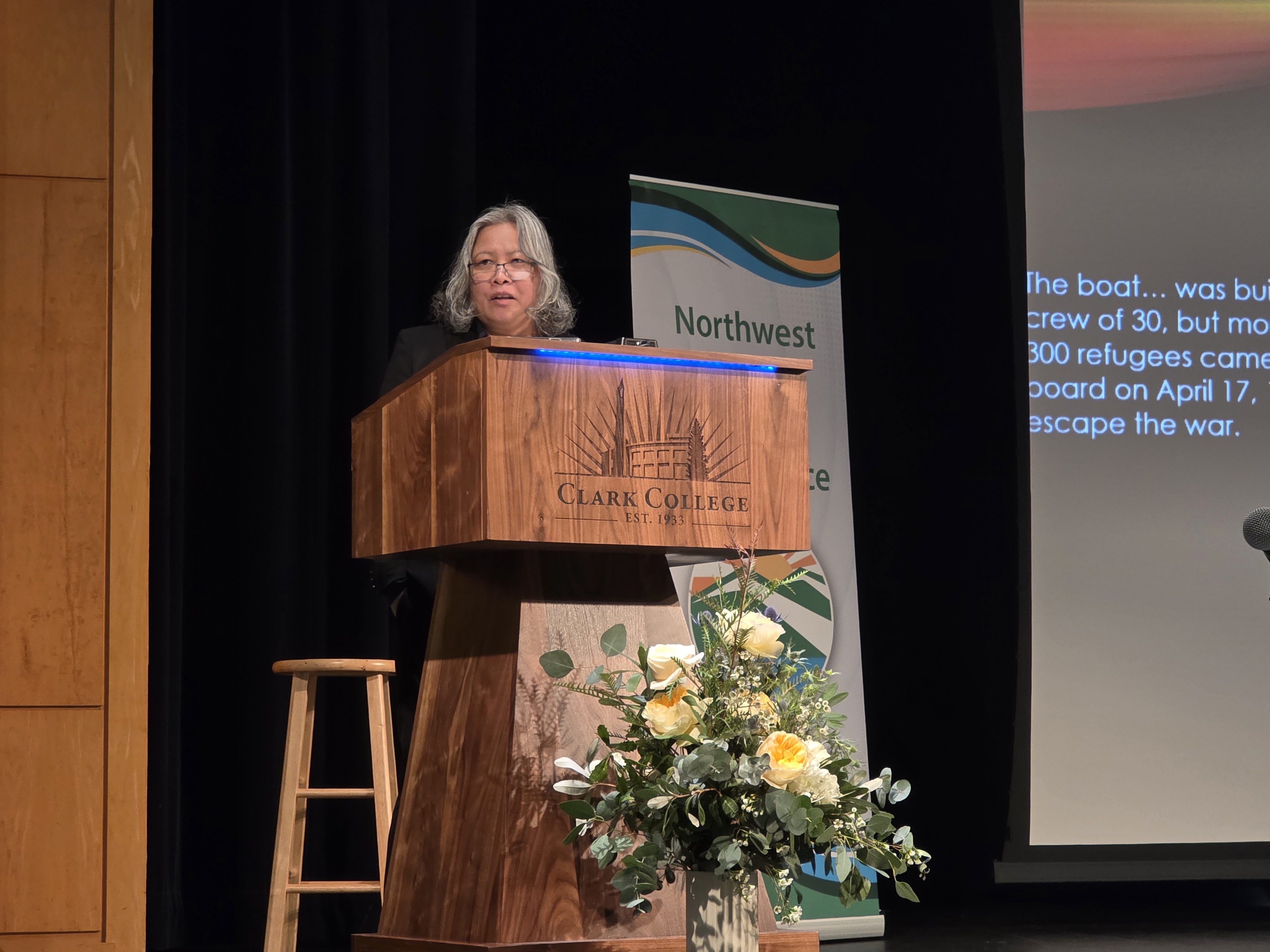 Putsata Reang speaking behind a podium