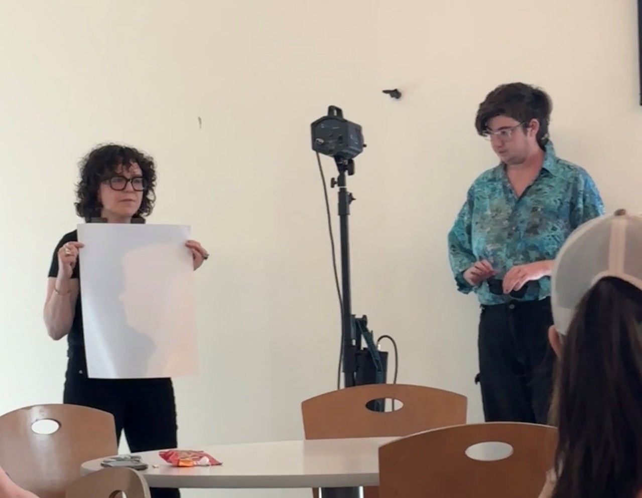 Artist Rachel Wolf holds up darkroom paper.