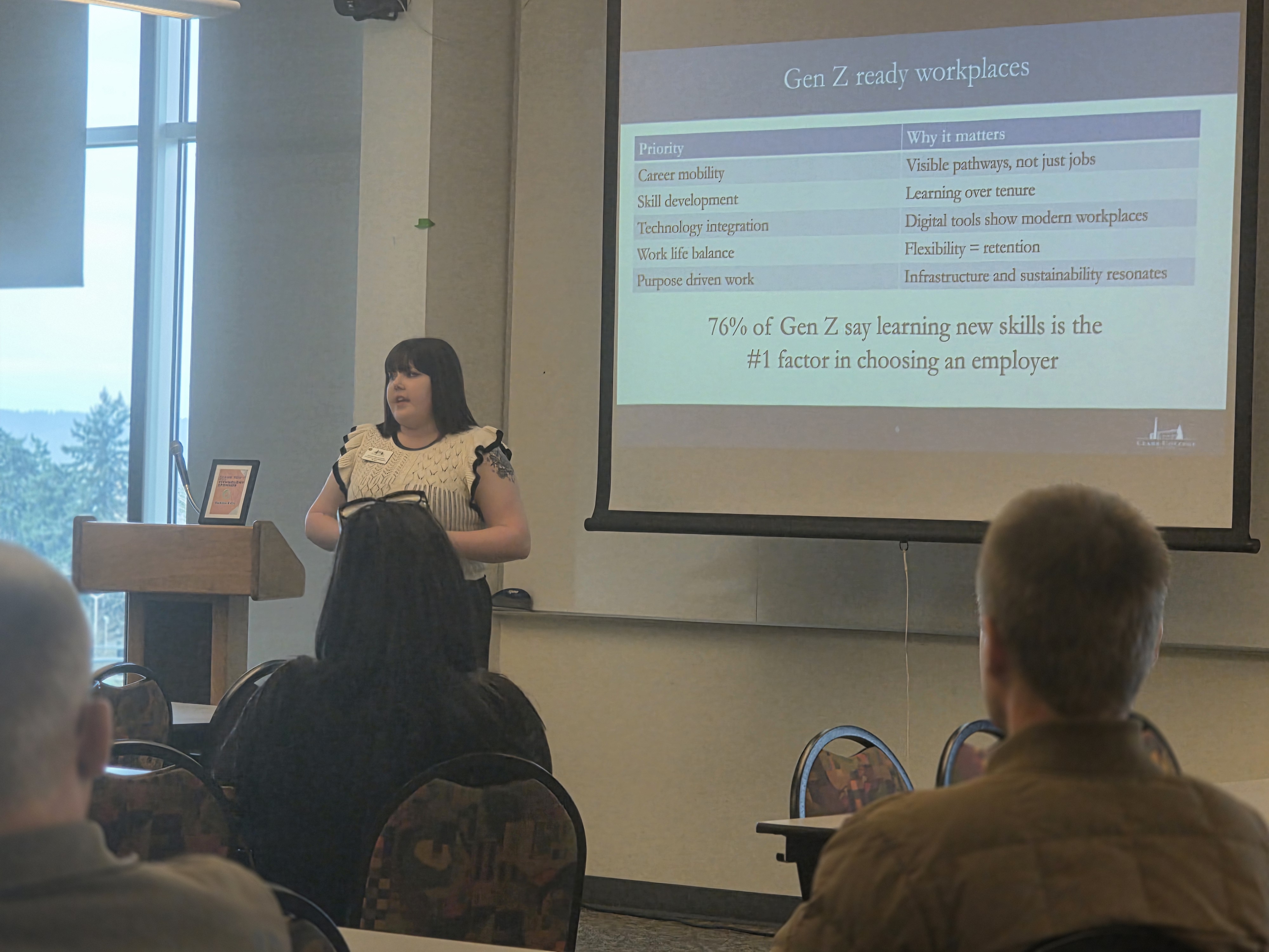 Stephanie Leeper presenting in front of a screen during Construction Summit