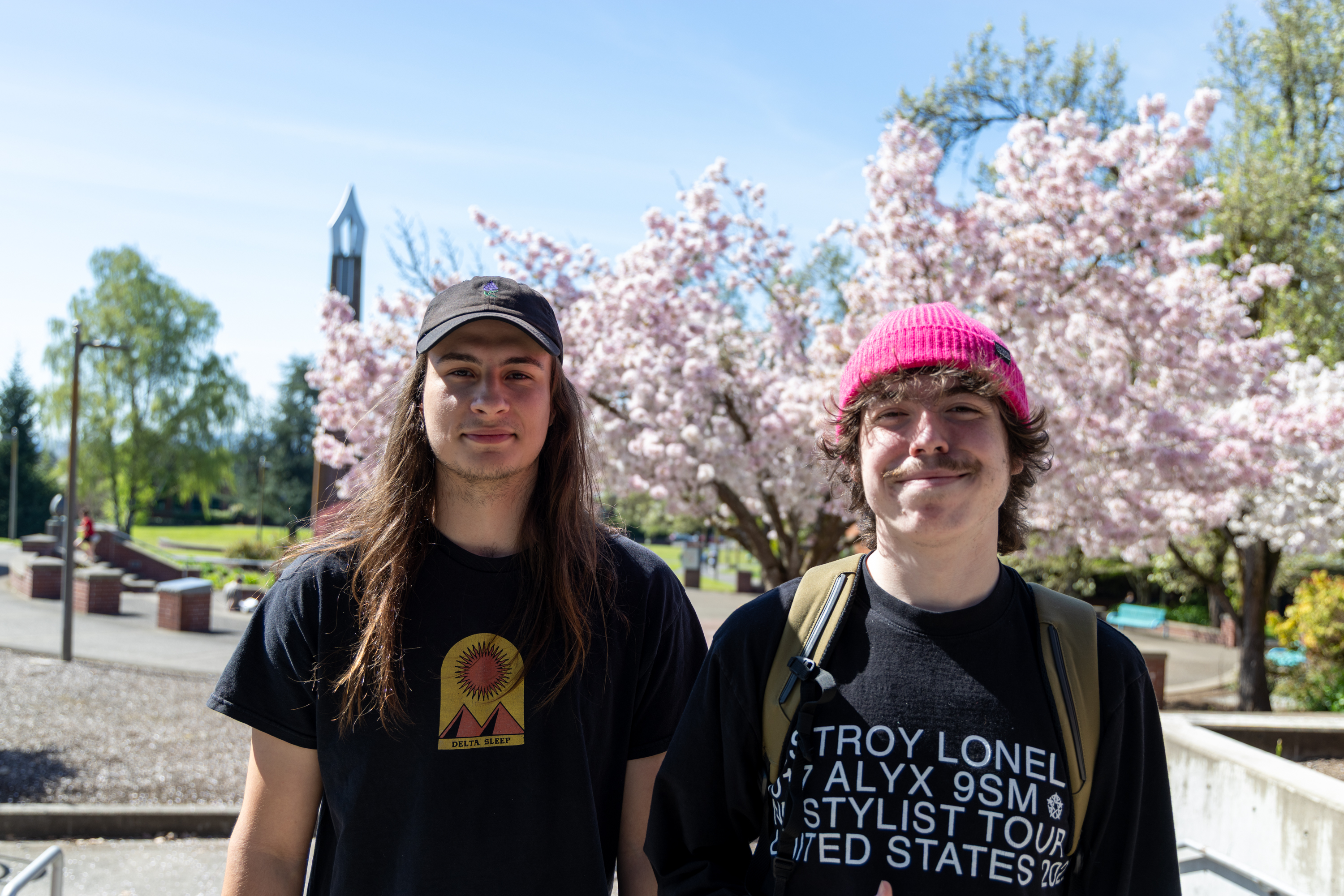 Two students smiling outside on campus
