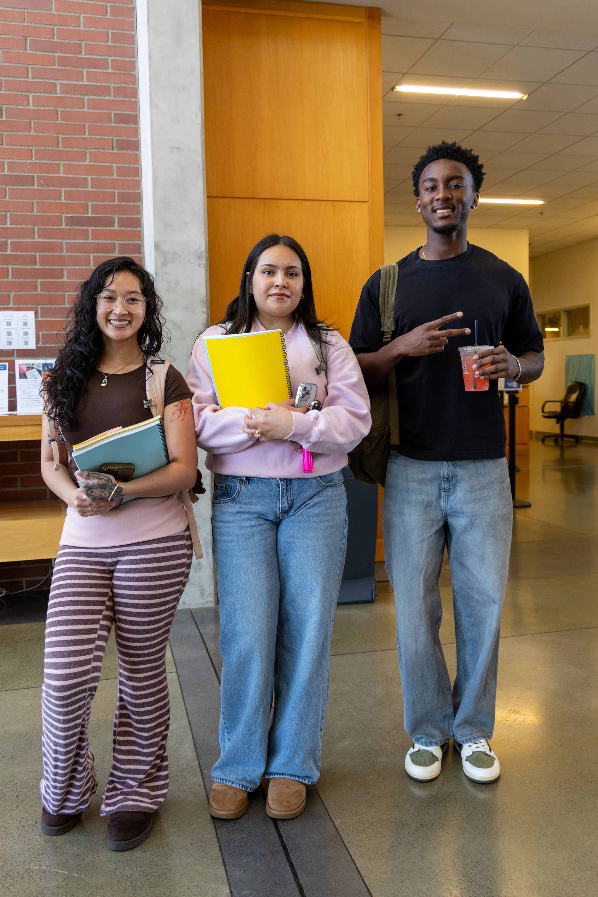 Three students smiling in Gaiser Hall