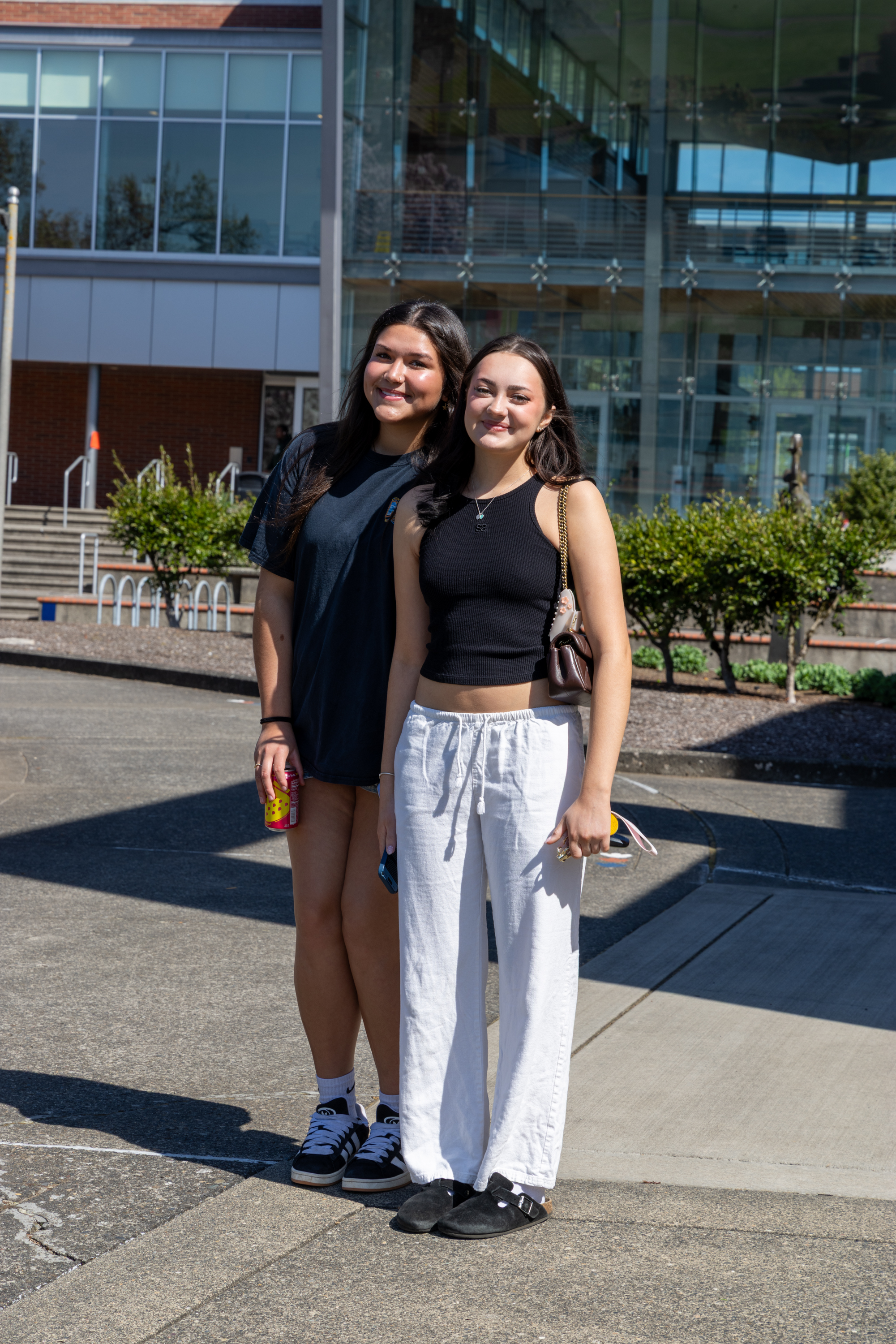 Two students smiling outside on campus