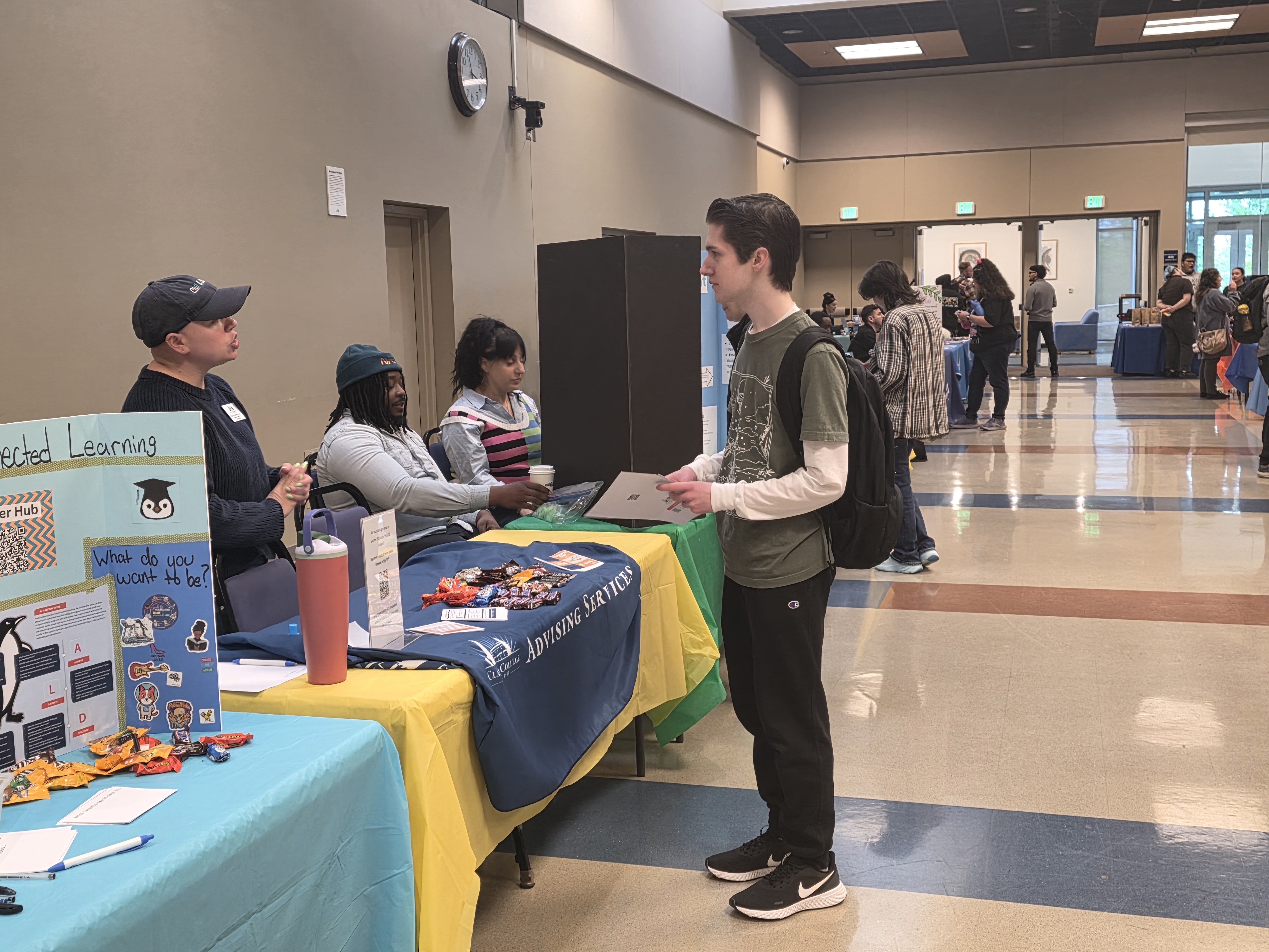 Student speaking to someone at a booth at the Student Involvement Fair