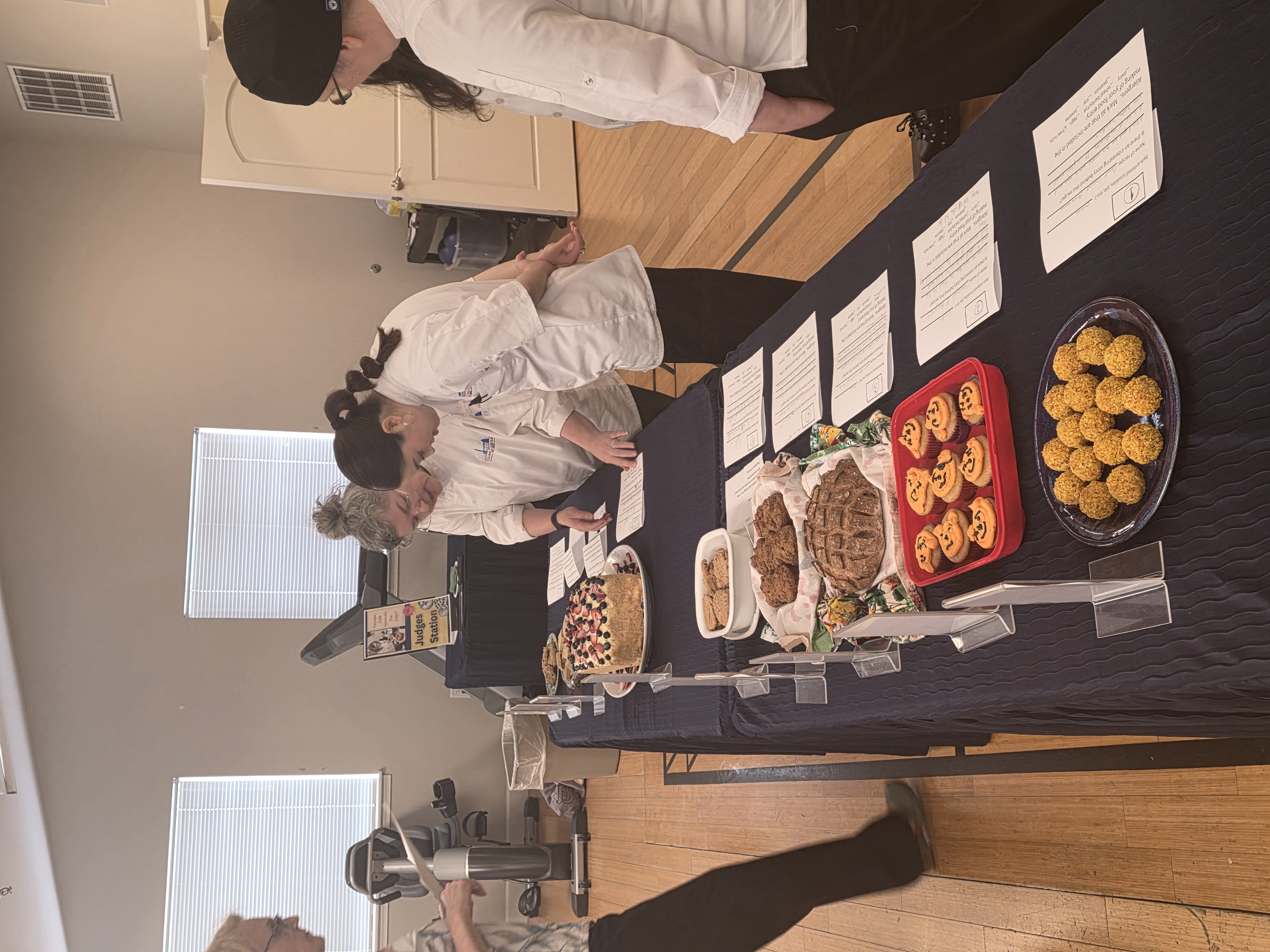 Contest judges review the baked goods sitting on the table