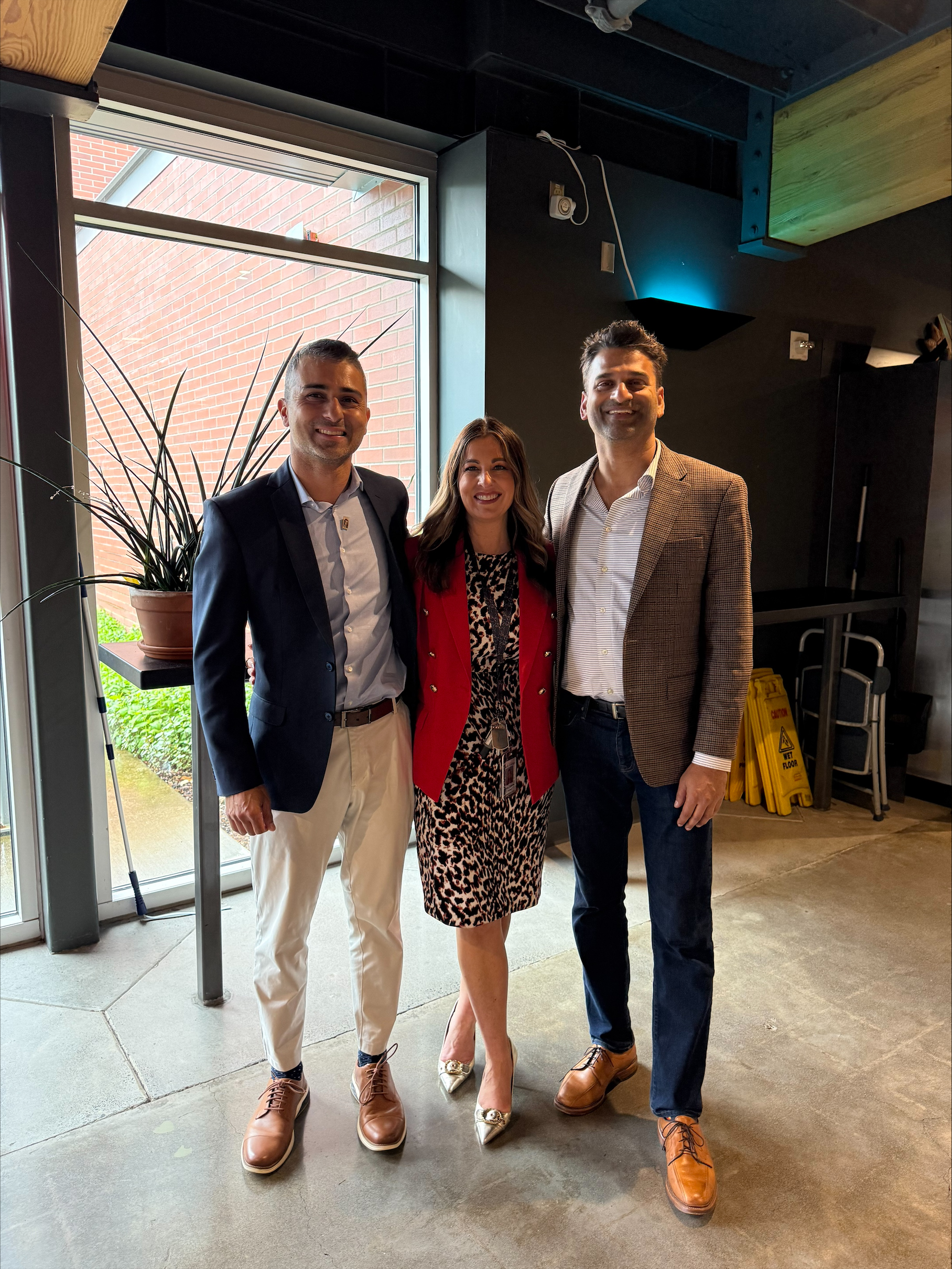 Professor Molly Lampos stands between Imran Haider and Nanu Iyer from WSU's College of Communications