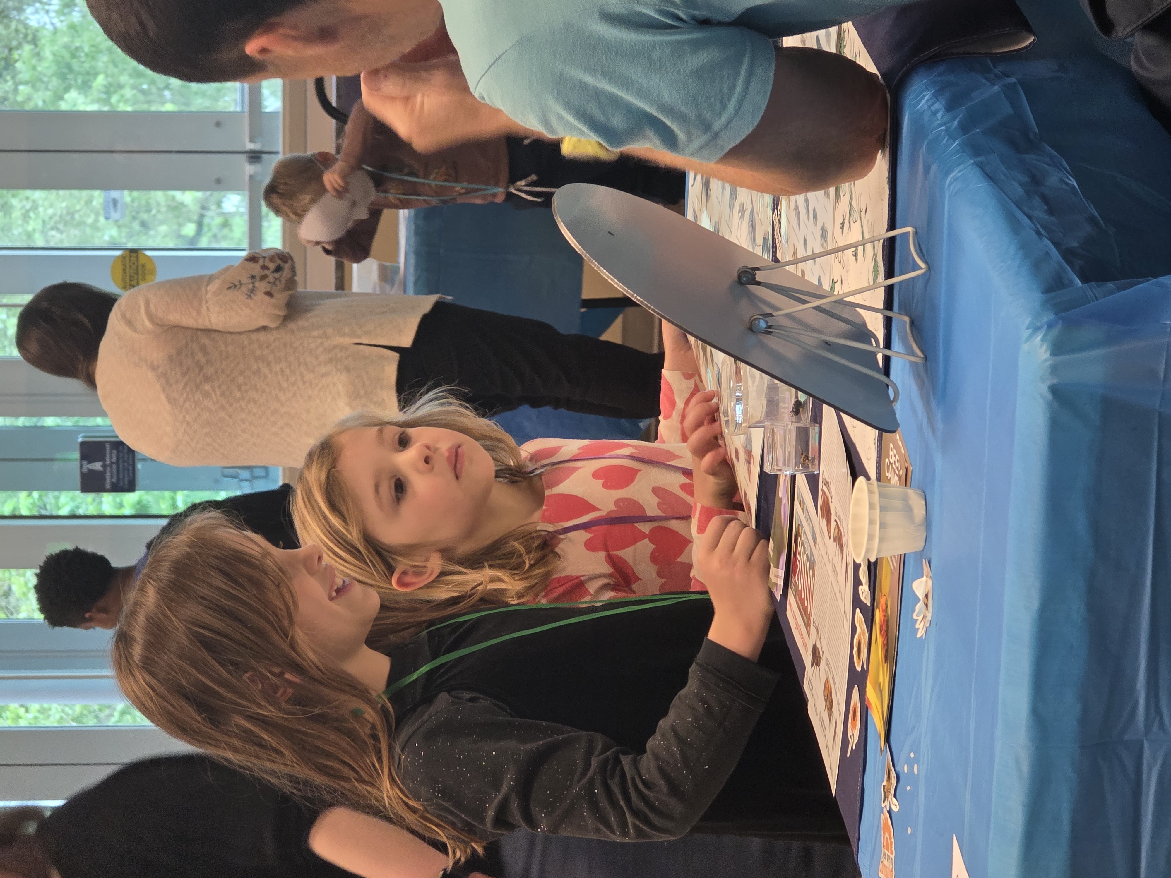 Two young girls engage with the Pollinator Club