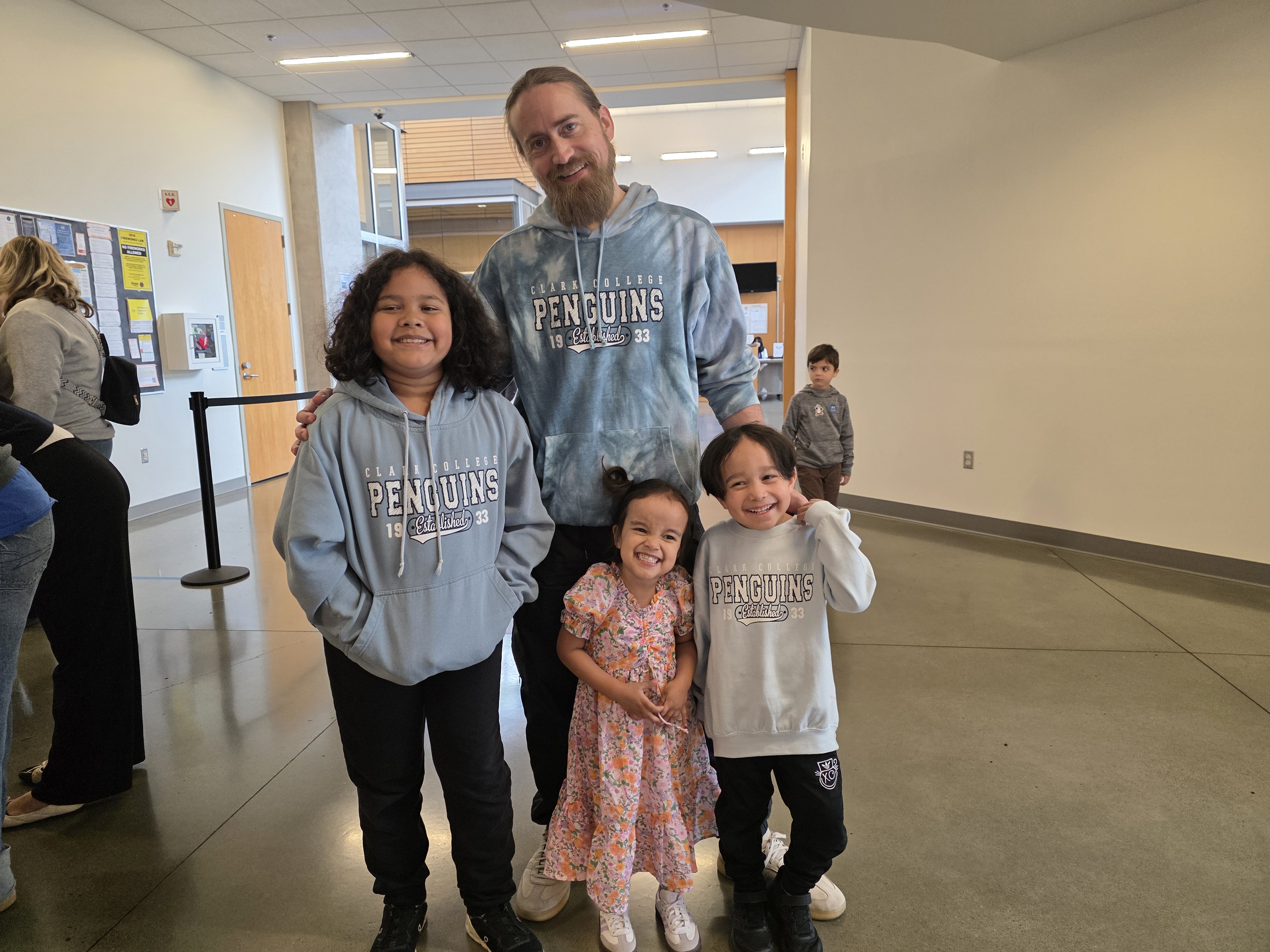 Husband and children of Clark employee, dressed in Clark gear