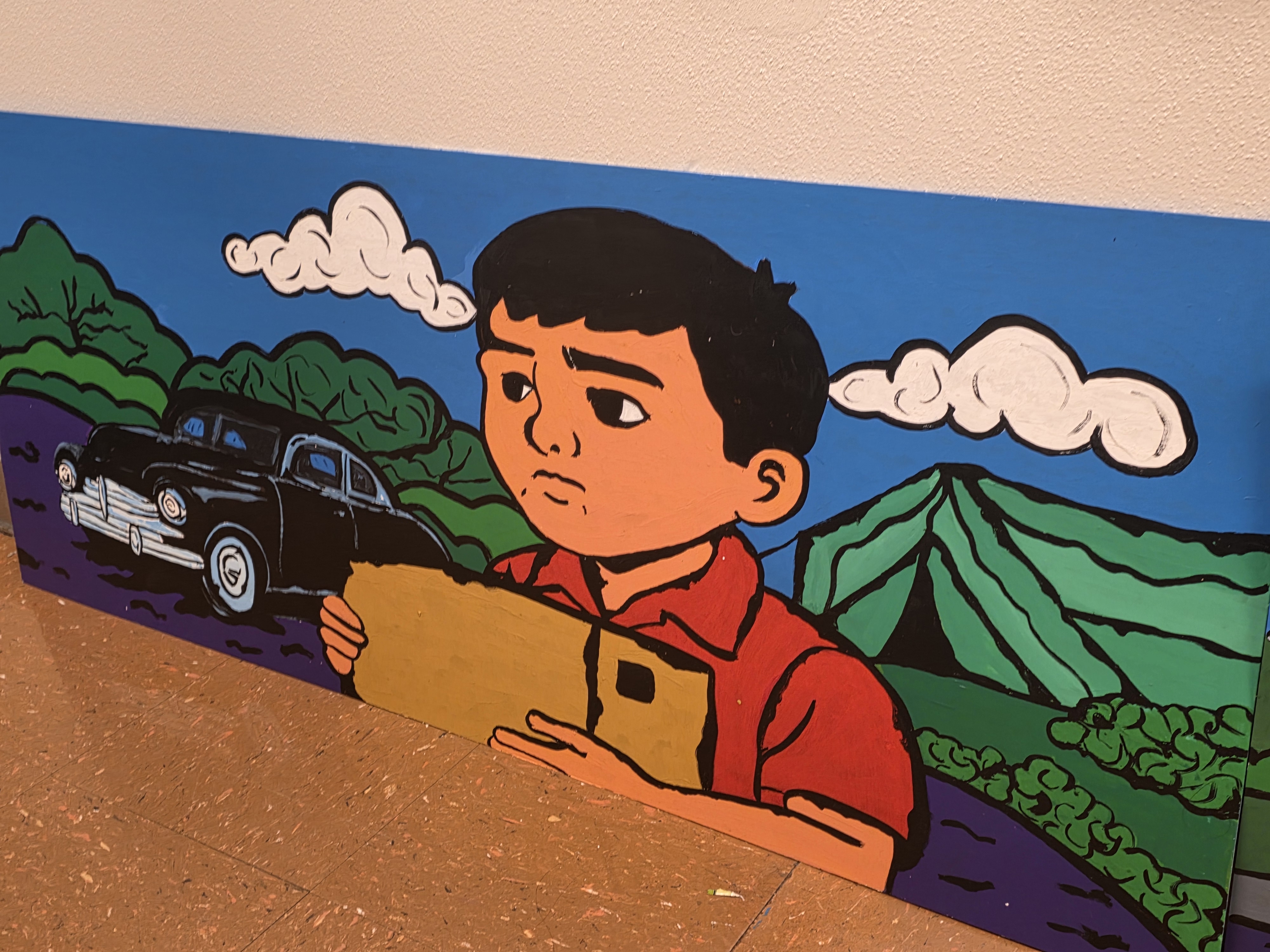 One panel from a mural, depicting a little boy holding a cardboard box
