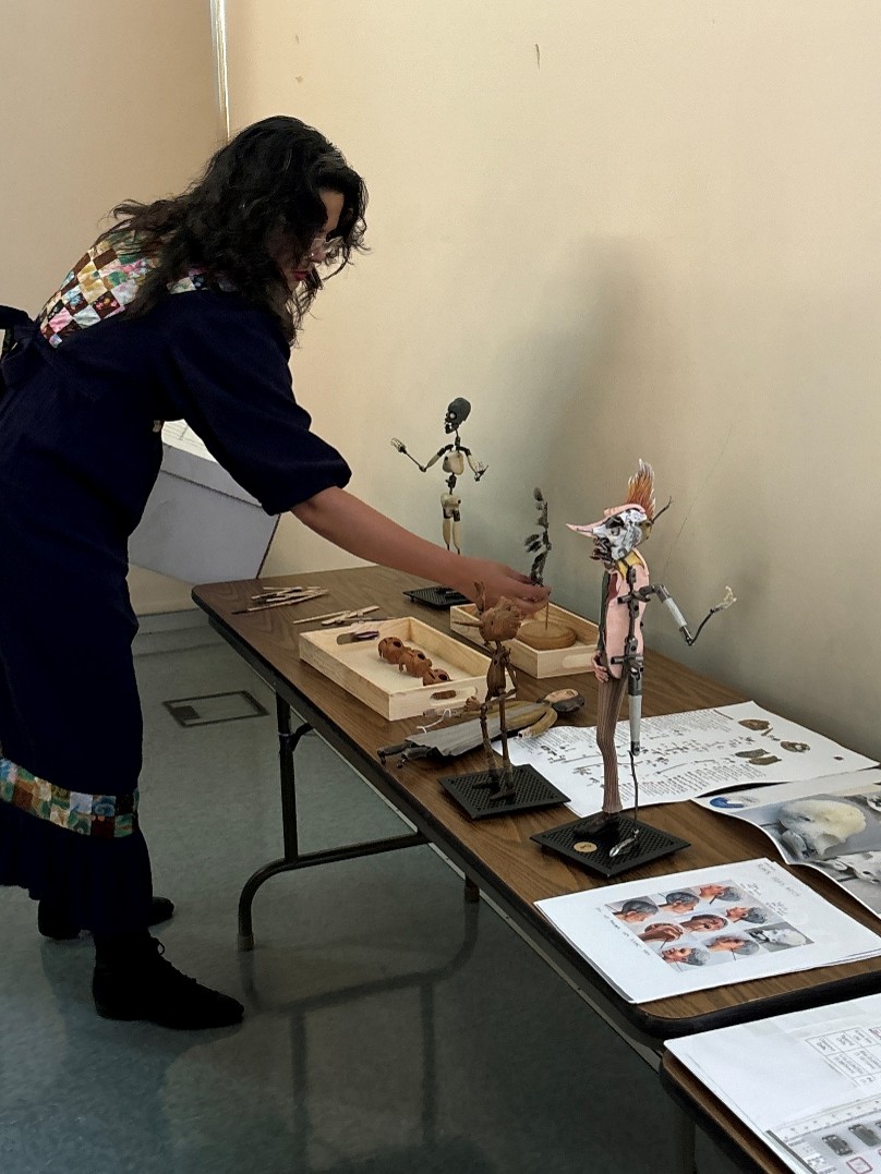 Artist Miel Margarita setting up armatures from animation projects on a table