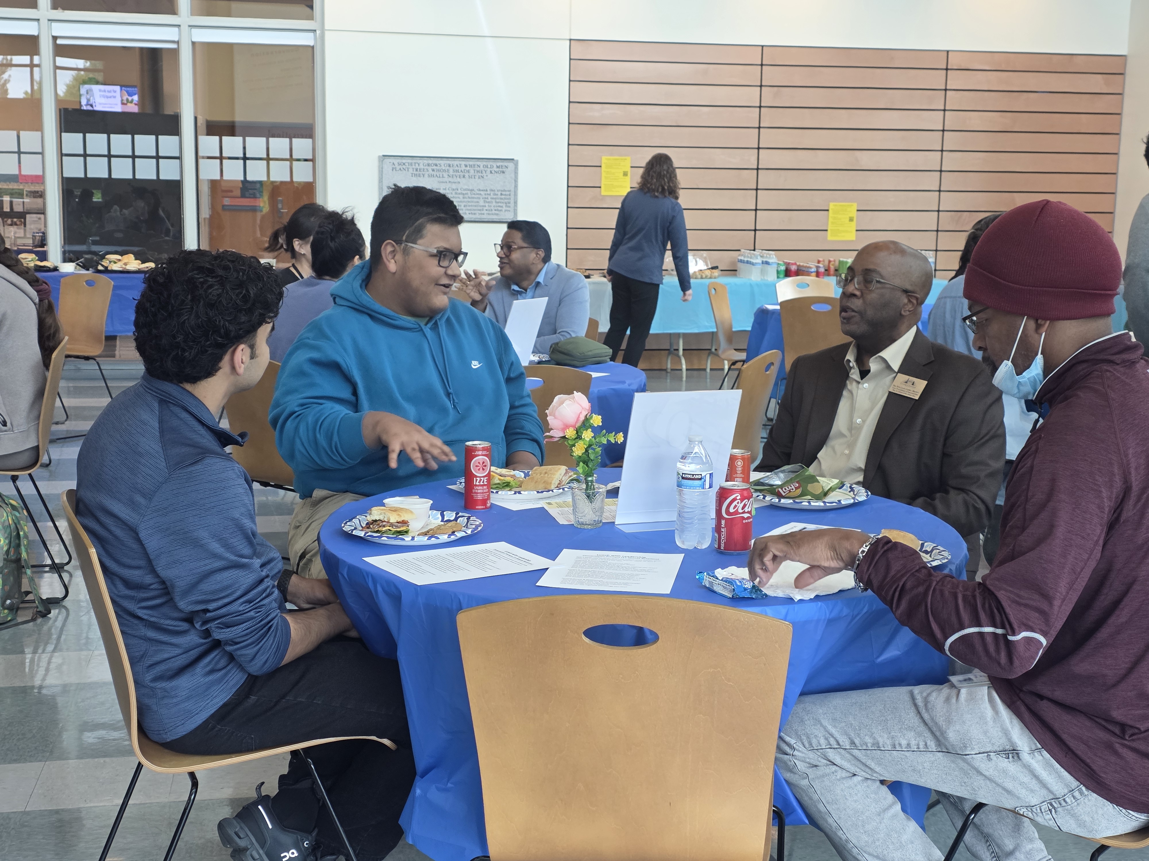 Dr. Brown and students in conversation at a table
