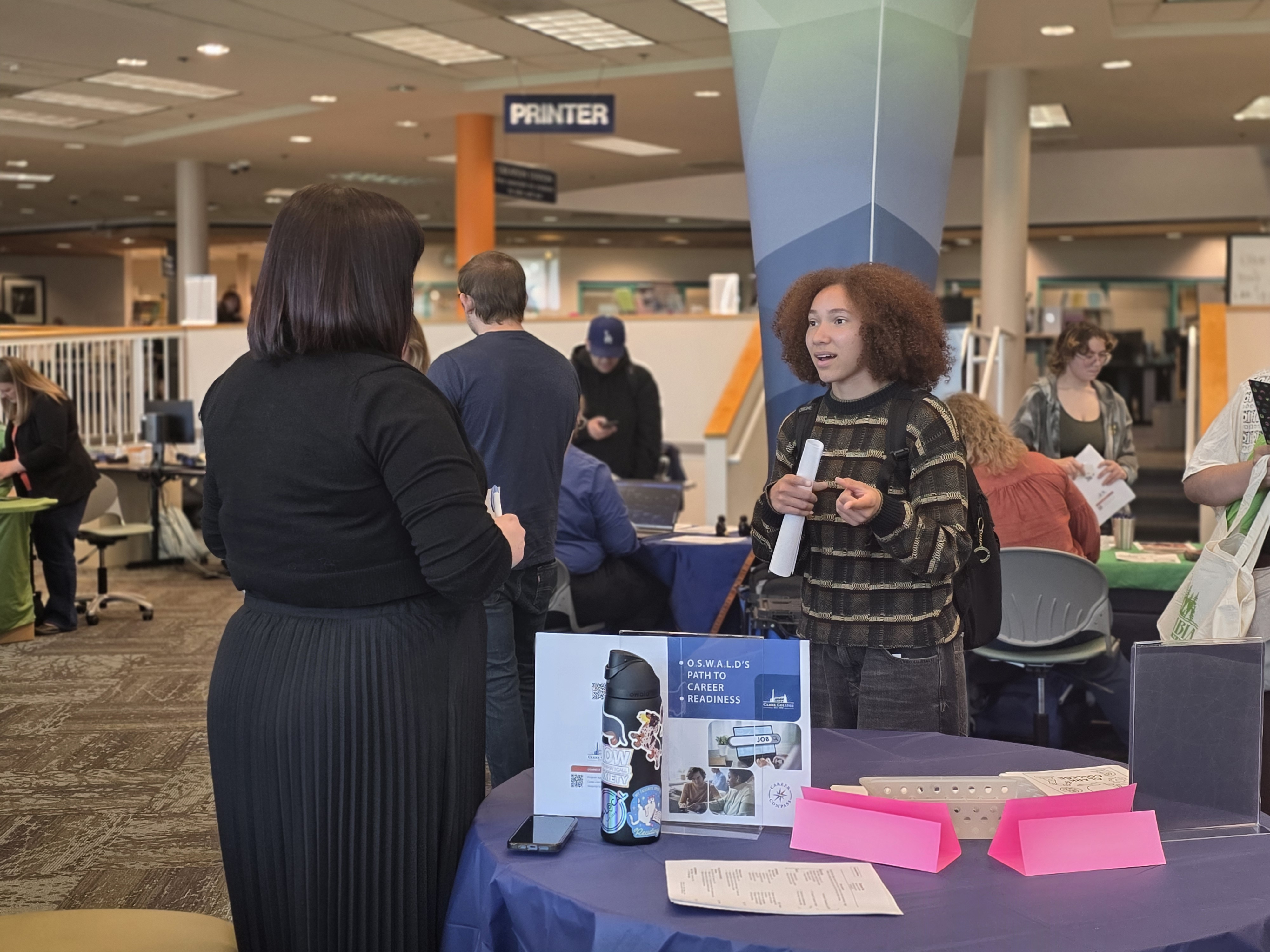 Stephanie Leeper speaking with a student