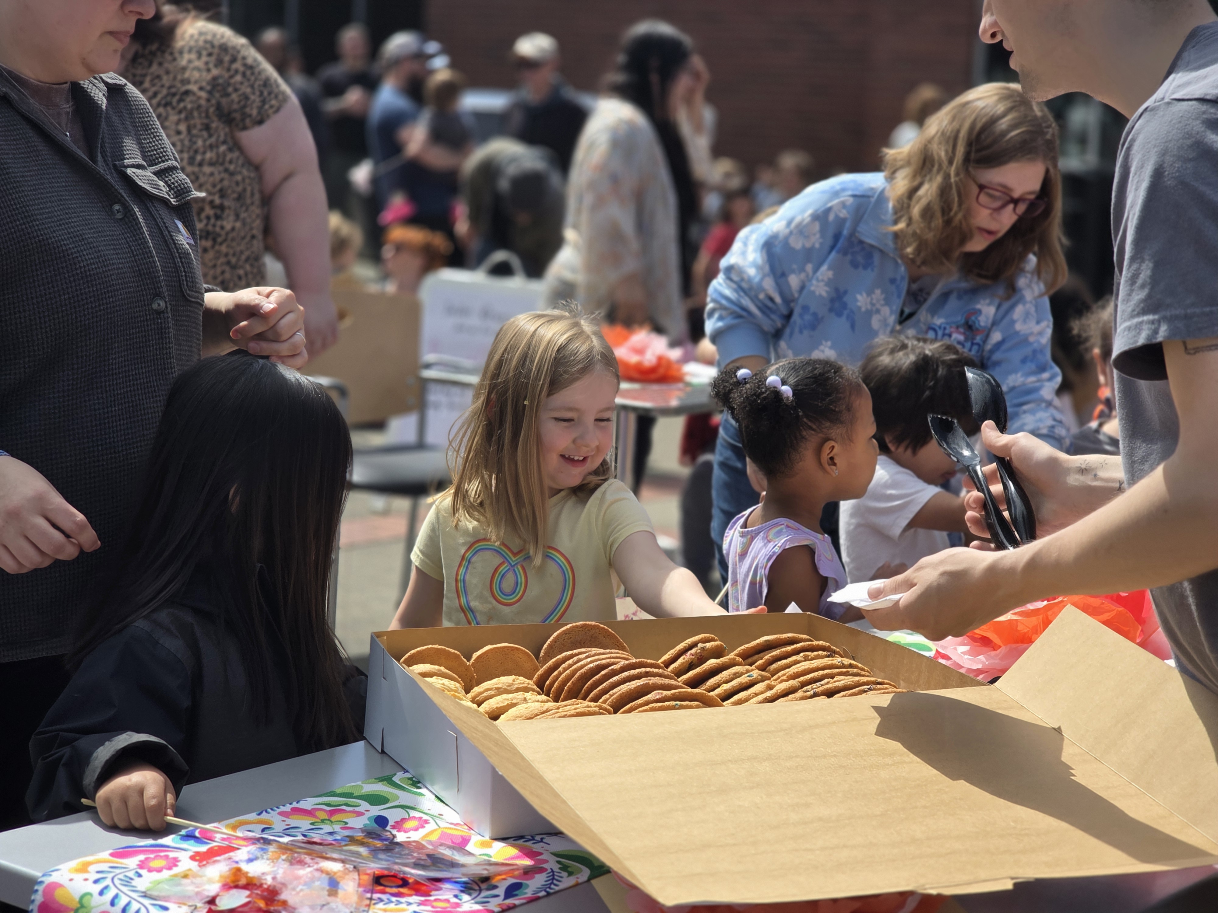 Little girl smiling in front of a box of cookies