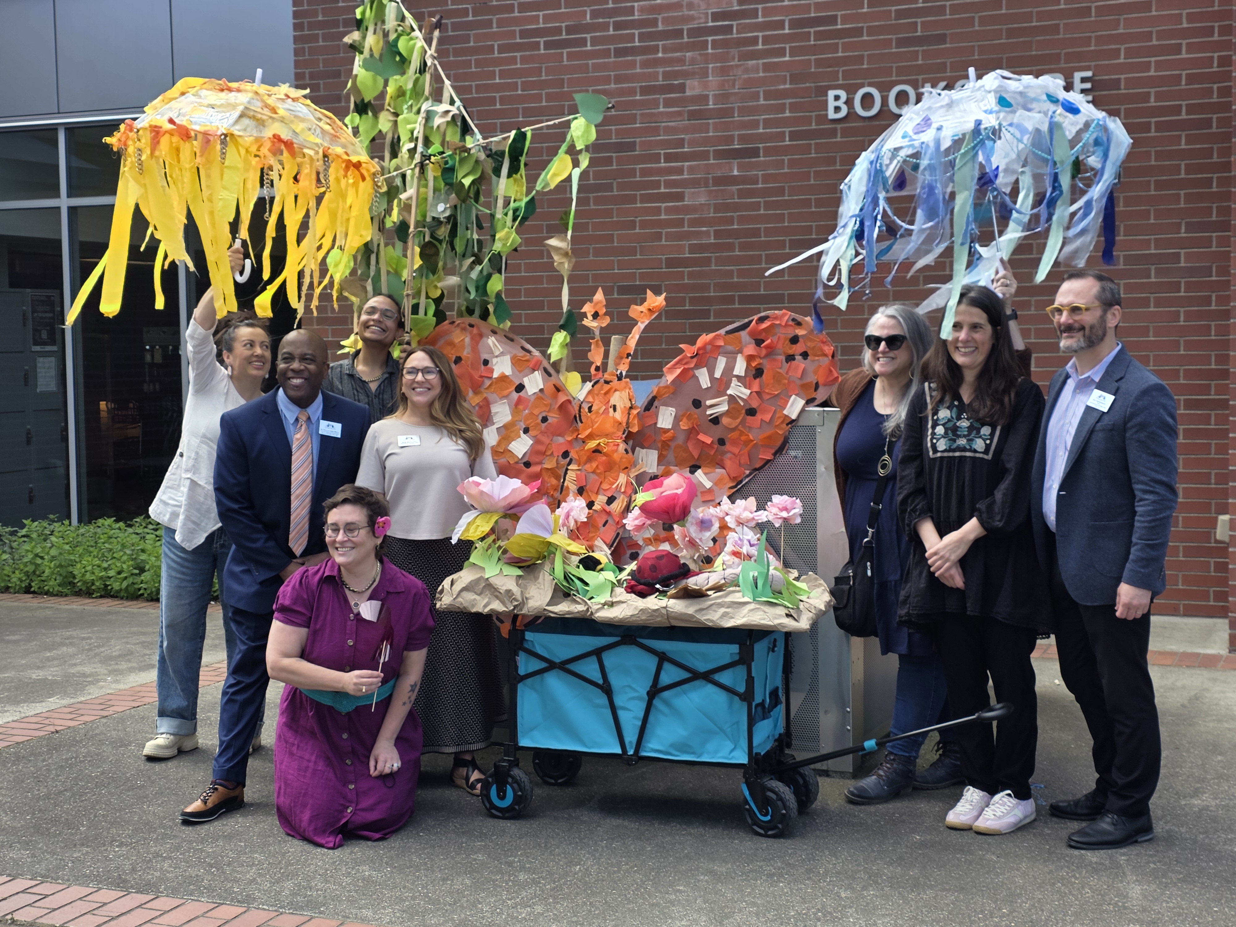 Staff from Clark College and Oregon Children's Theatre in front of props designed during residency