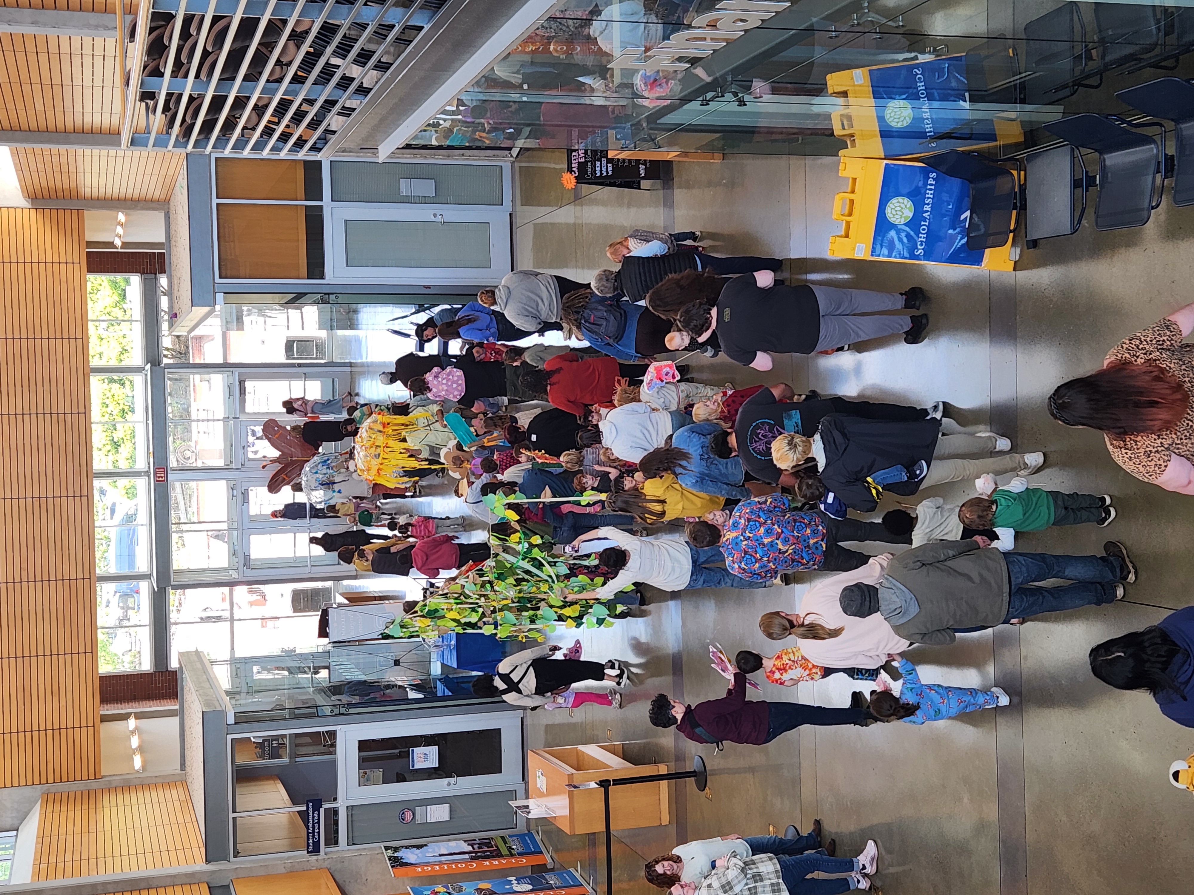 Parade-goers marching through Gaiser Hall