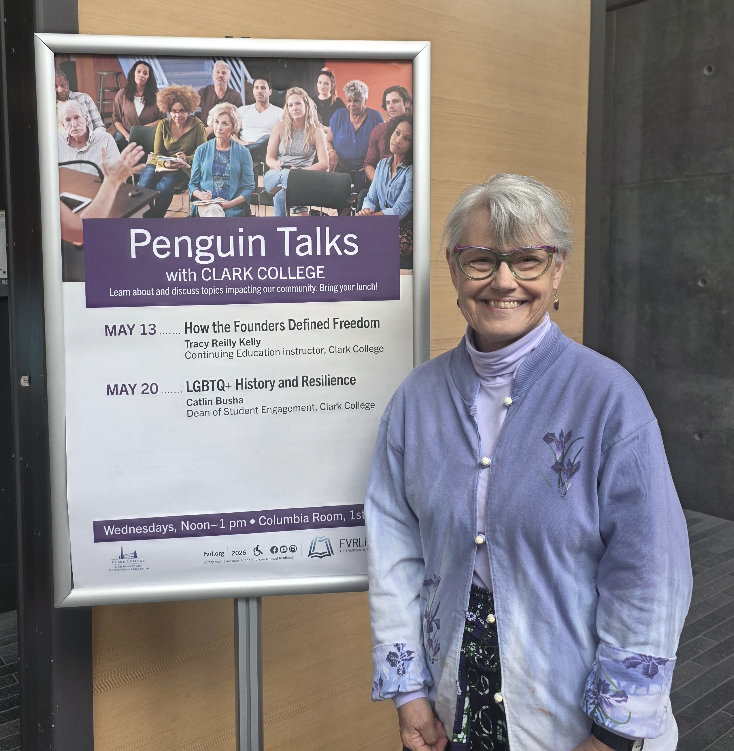 Tracy stands next to a sign announcing Penguin Talks