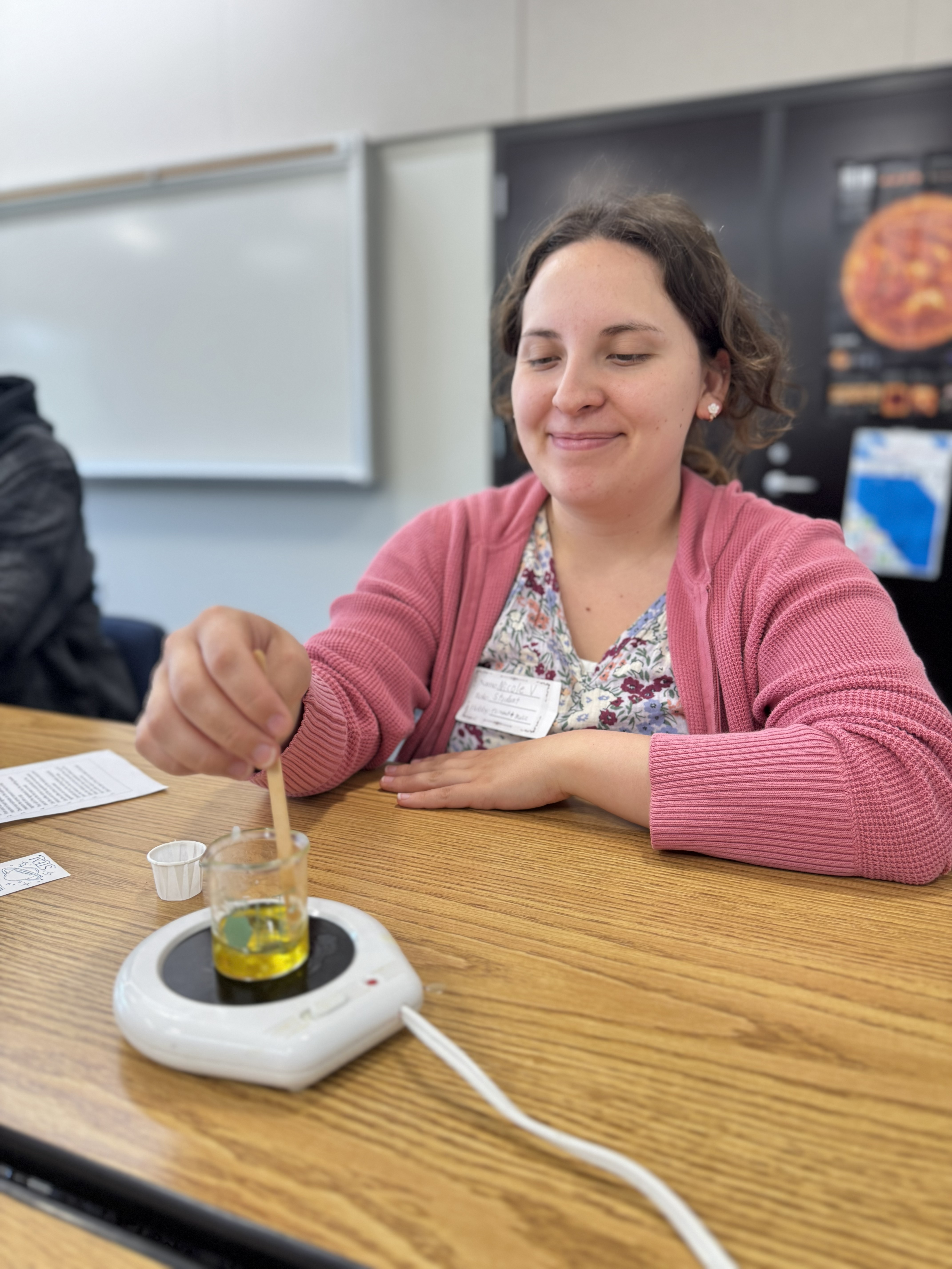 Student melting wax on a burner