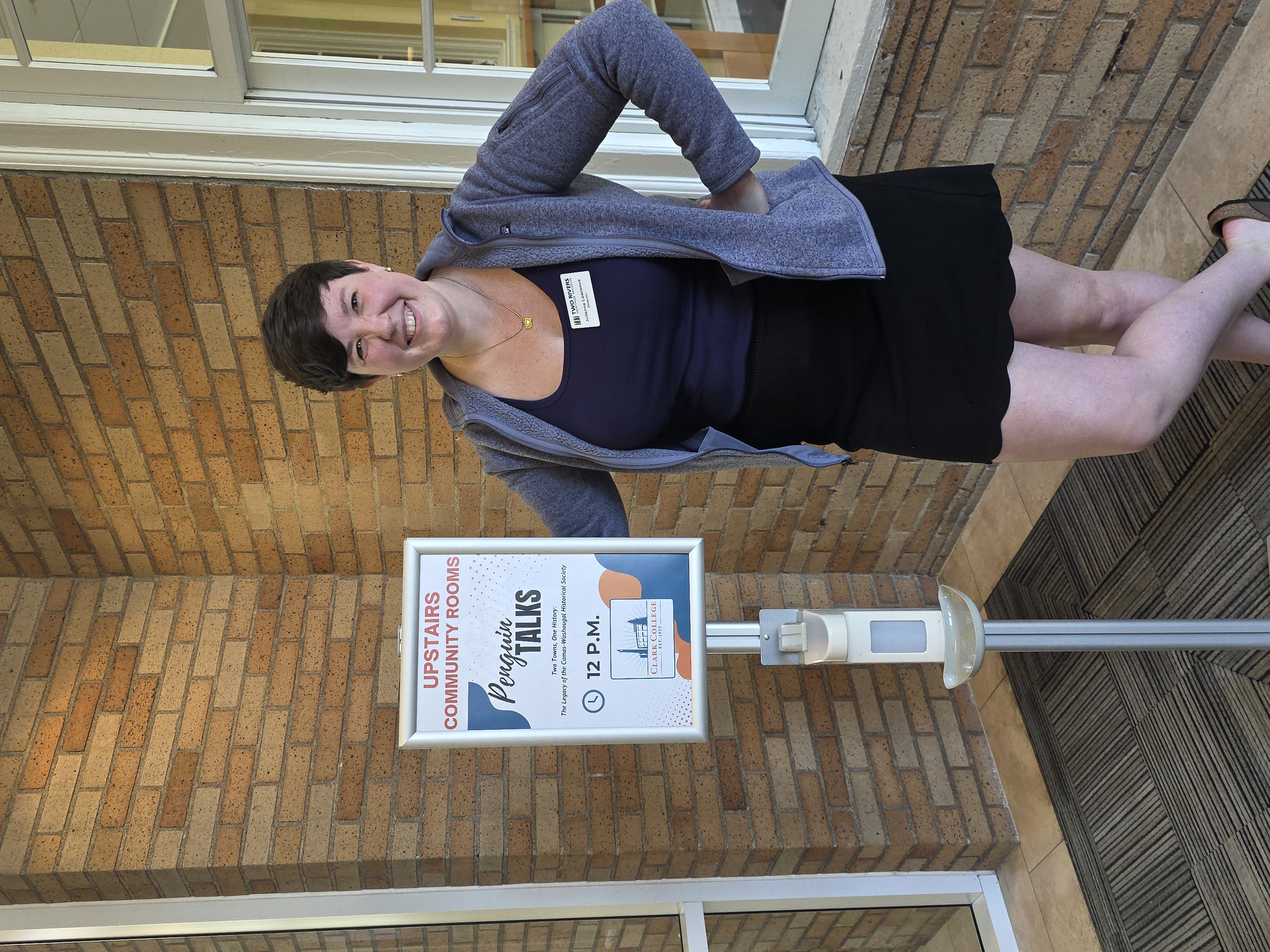 Julianne Lawrence standing next to a sign announcing Penguin Talks